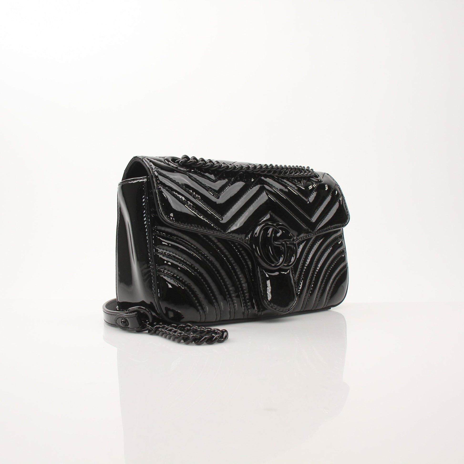 Gucci GG Marmont black matelassé shoulder handbag with chain strap and gold-toned hardware, stylish and luxurious accessory.
