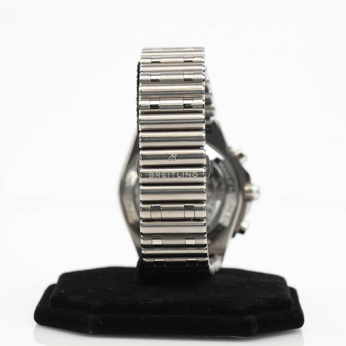 Titanium Breitling Chronomat B01 wristwatch with black dial and chronograph features, showcased on a display stand.