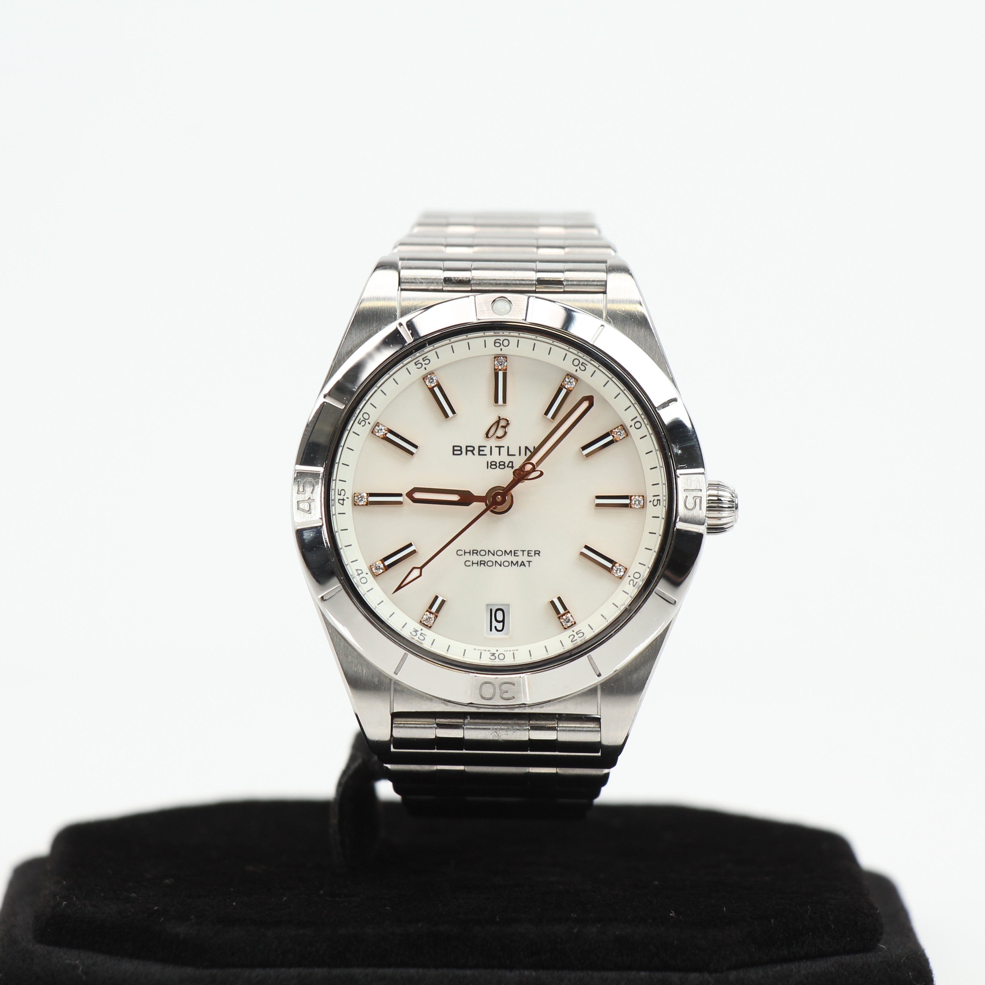 Stainless steel Breitling Chronomat watch with black dial and chronograph features, displayed on a white background.