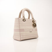 Christian Dior embroidered canvas Lady D-Lite handbag with gold accents and floral embroidery, showcasing elegant craftsmanship.