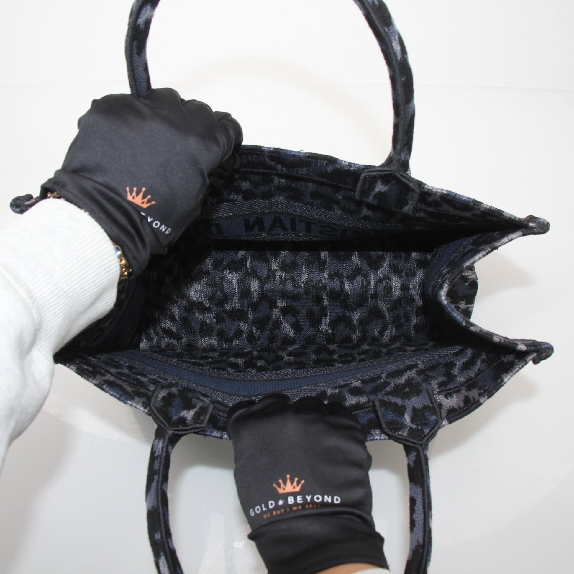 Christian Dior Leopard Book Tote handbag in beige with black leopard print and gold-tone handles, casual and stylish accessory.
