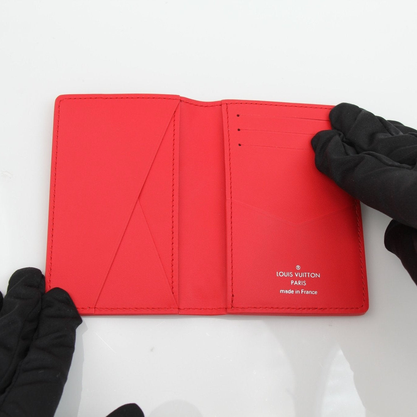 Louis Vuitton Red Empreinte leather card holder with multiple card slots and gold-tone hardware, compact and stylish.