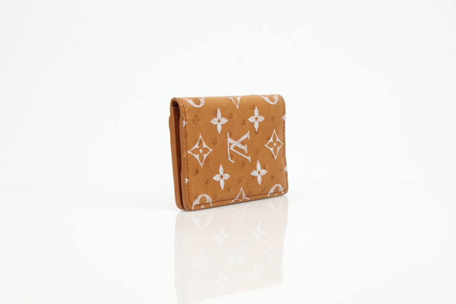 Louis Vuitton Pocket Organizer wallet in Monogram leather with multiple card slots and a sleek design.