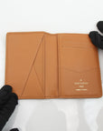 Louis Vuitton Pocket Organizer wallet in Monogram leather, featuring a sleek design and multiple card slots.