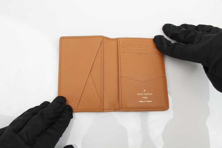 Louis Vuitton Pocket Organizer wallet in Monogram leather, featuring a sleek design and multiple card slots.