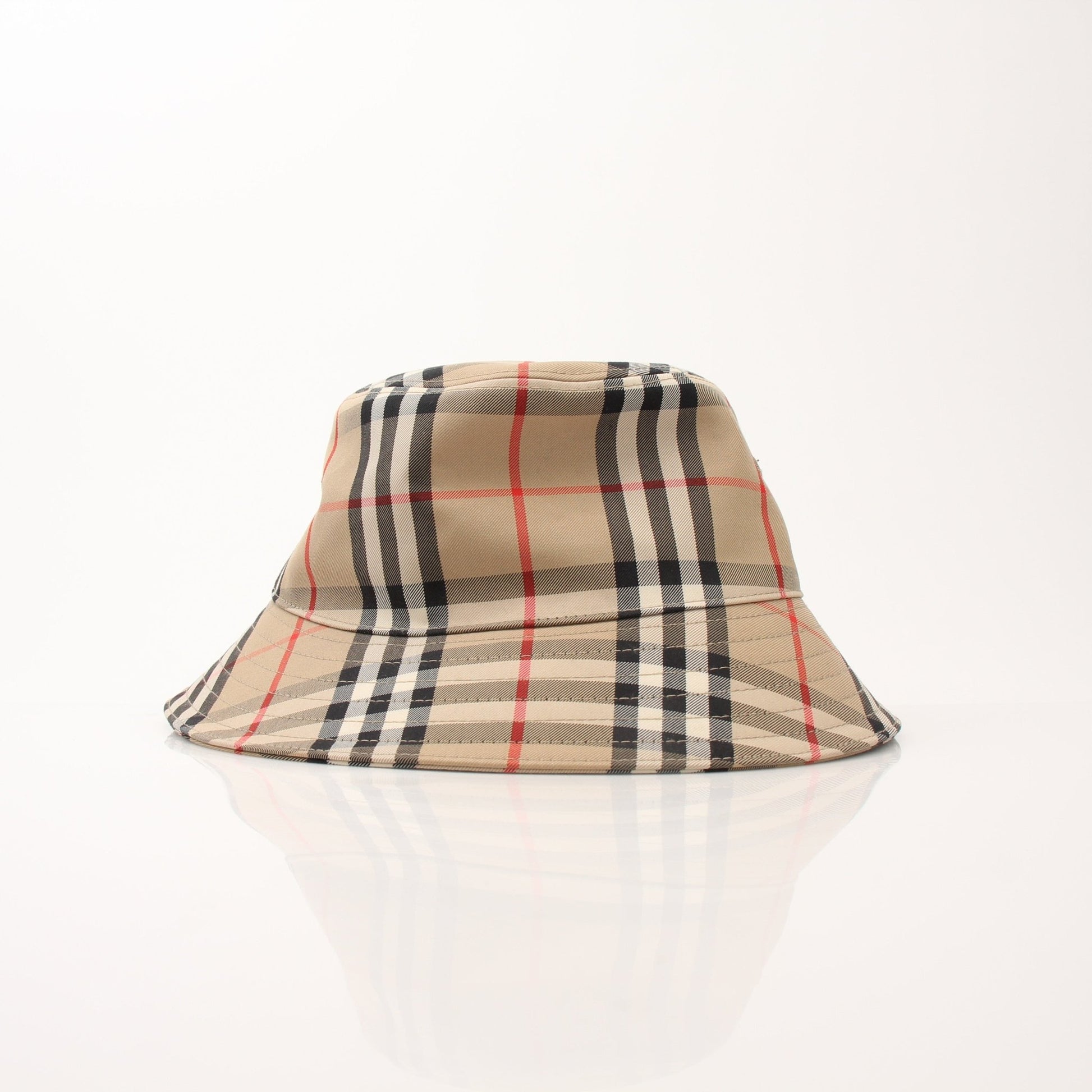 Burberry Kid’s Gabriel Vintage Check Bucket Hat, gold and beige accessories with classic check pattern, worn by a child.