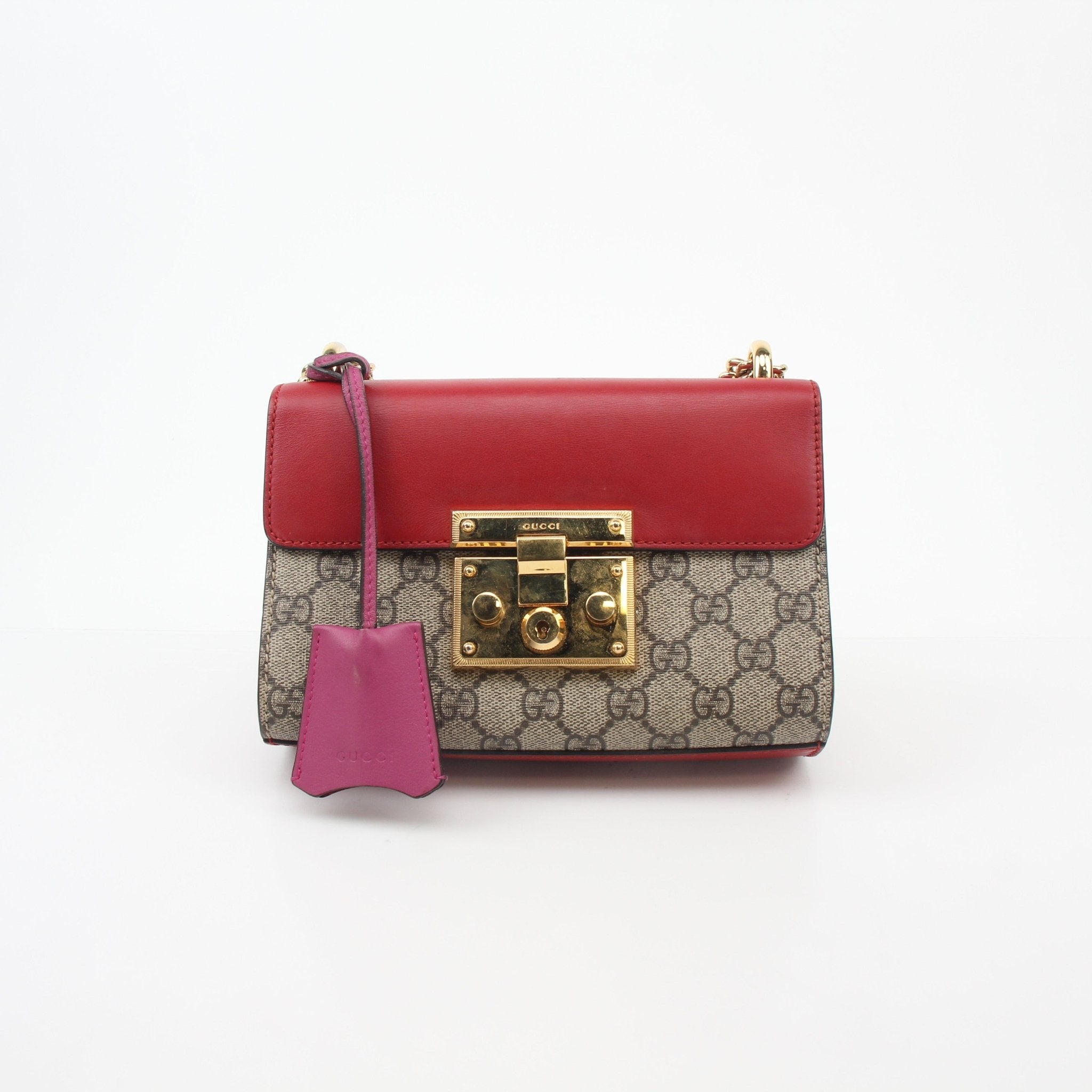Gucci GG Supreme Padlock small shoulder handbag with gold hardware and adjustable strap, featuring signature pattern and compact design.