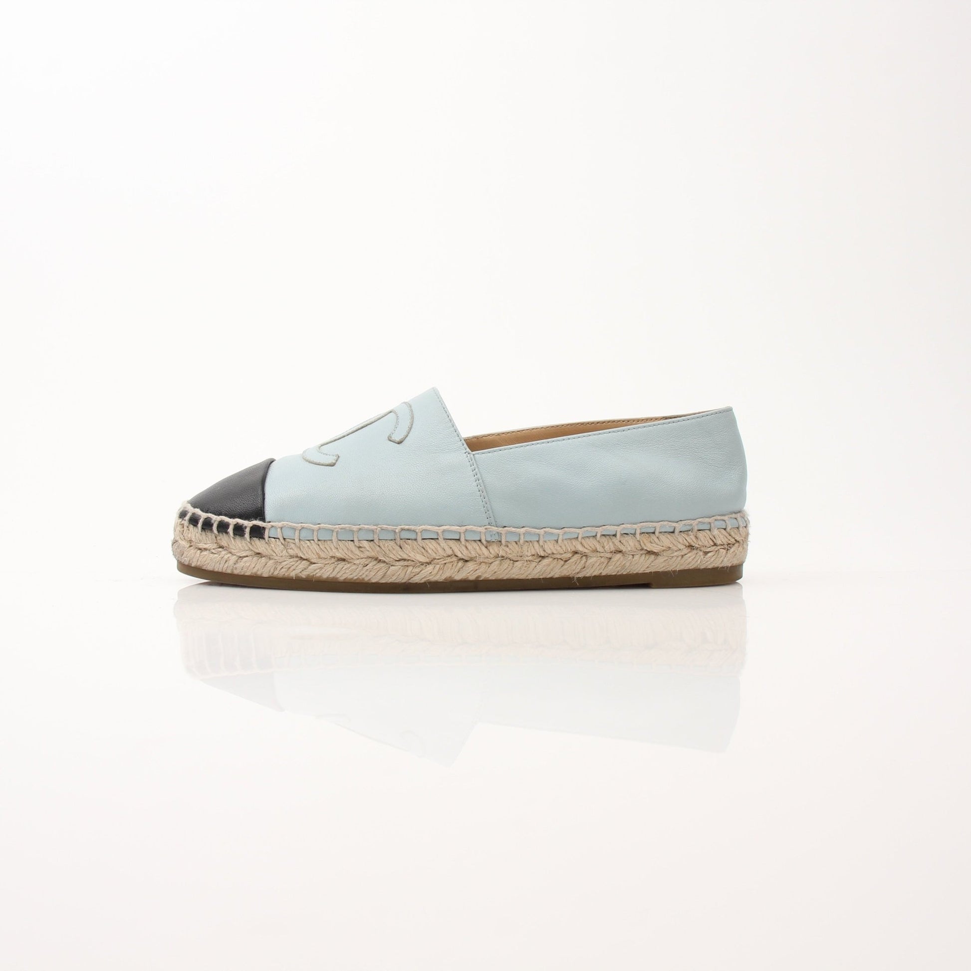 Gold & Beyond Chanel women’s CC leather espadrille shoes with beige and black design, featuring the iconic CC logo on the strap.