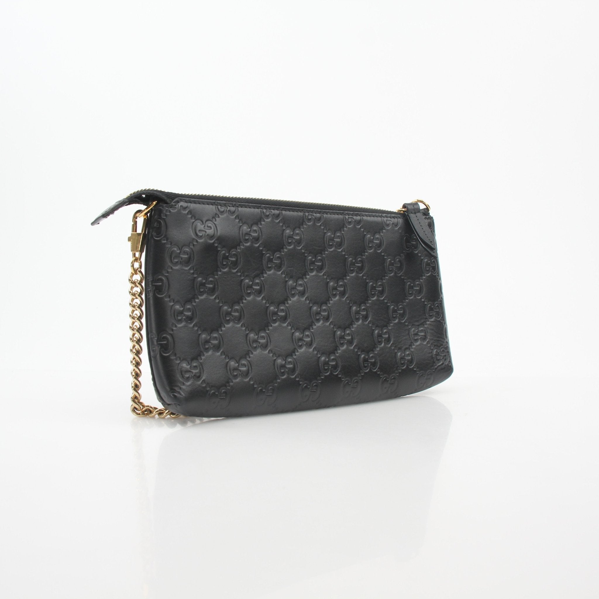 Gucci black Microguccissima chain pouch handbag with gold chain strap and logo pattern, stylish accessory for daily use.