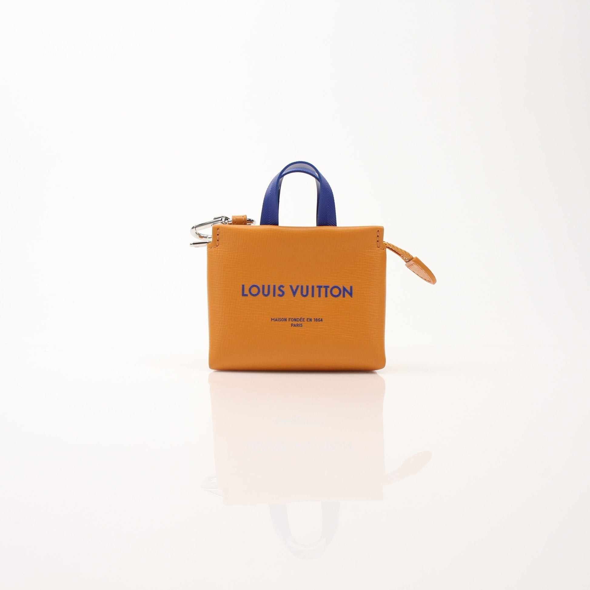 Louis Vuitton mini tote charm bag accessory featuring gold hardware and detailed design, suitable for decorating bags or keys.