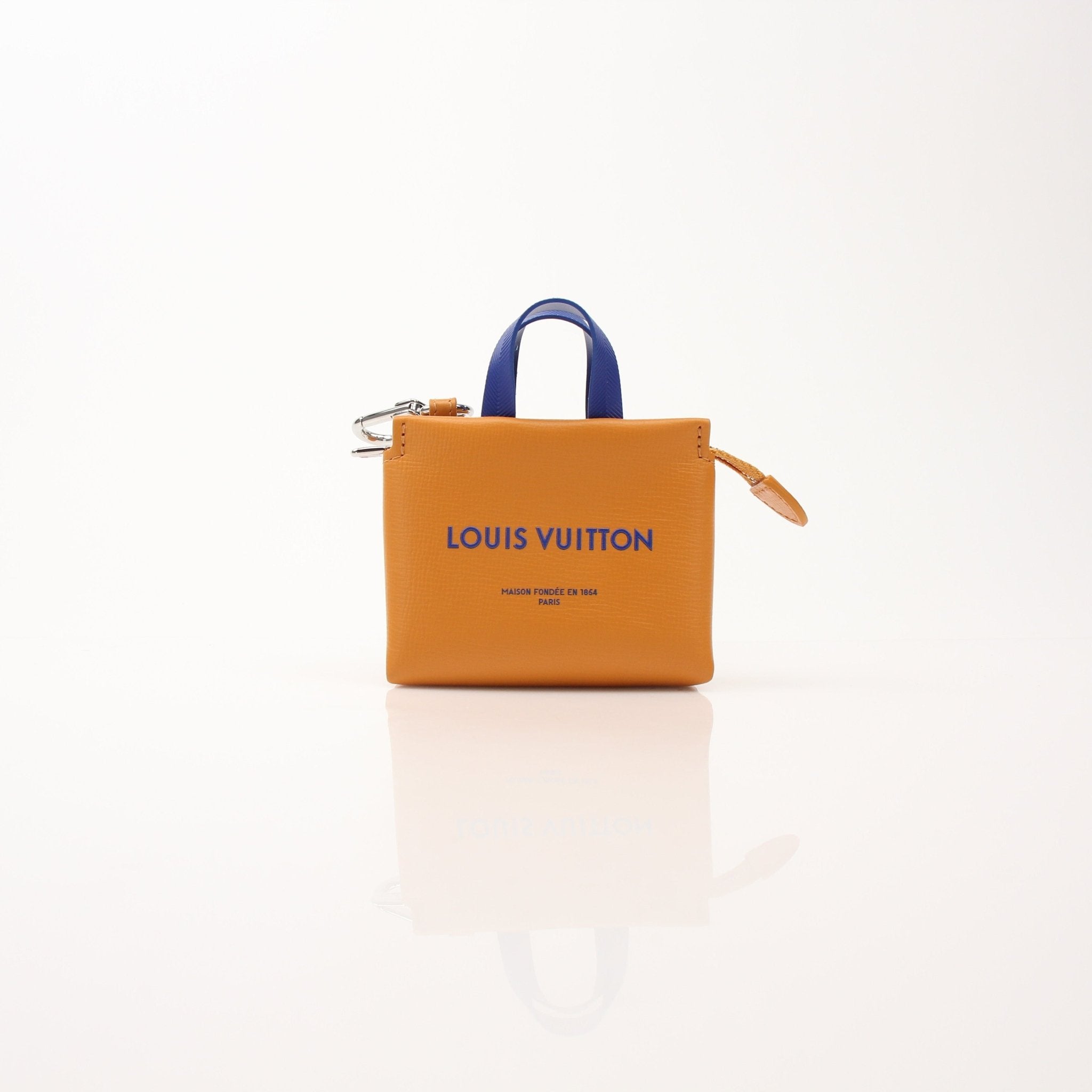 Louis Vuitton mini tote charm bag accessory featuring gold hardware and detailed design, suitable for decorating bags or keys.