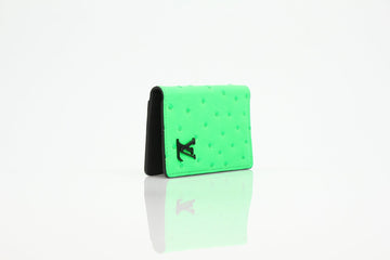 Louis Vuitton Pocket Organizer wallet in vibrant neon green ostrich leather with sleek design and multiple card slots.