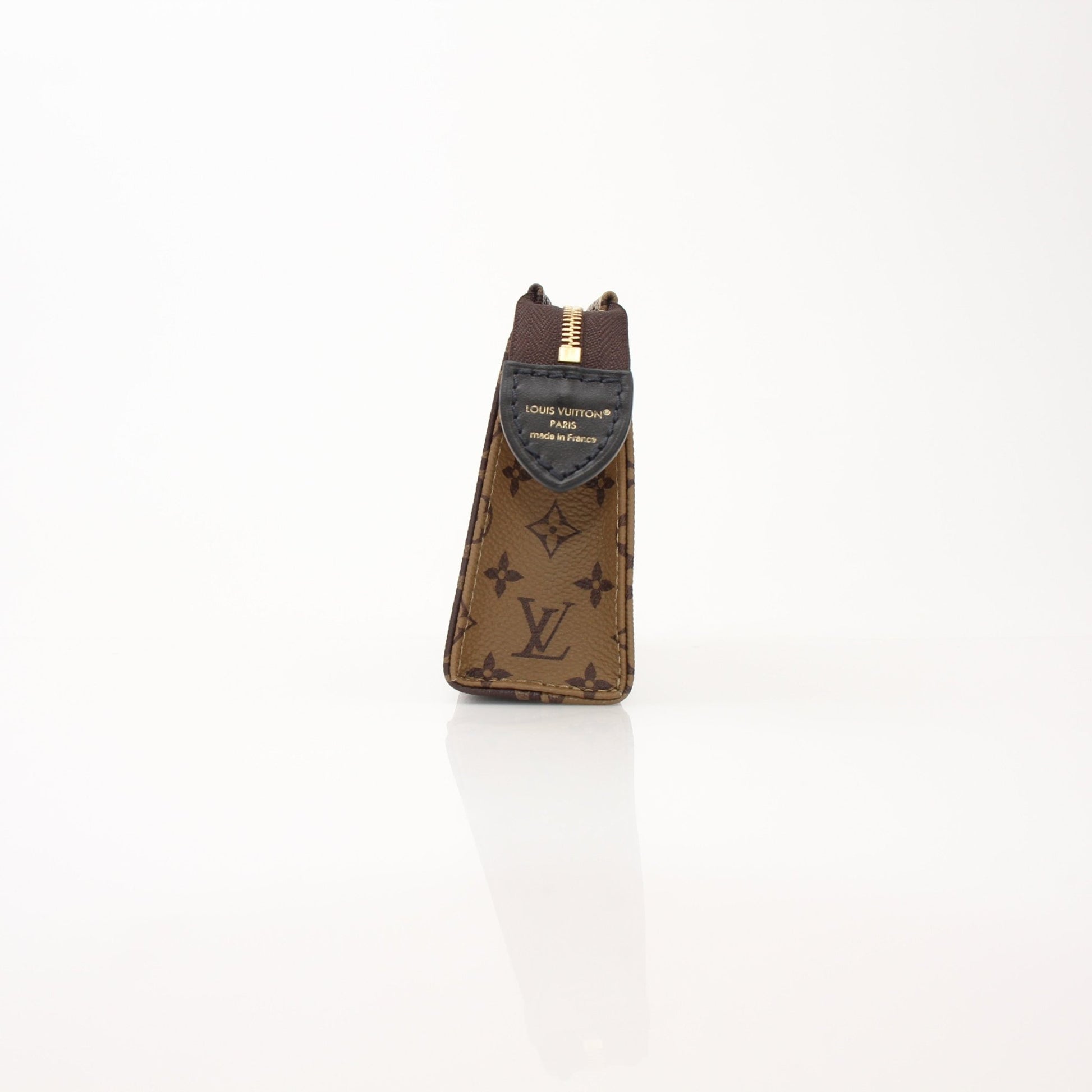Louis Vuitton Toiletry Pouch 15 vanity case in brown monogram canvas with leather trim, featuring gold-tone hardware and zip closure.