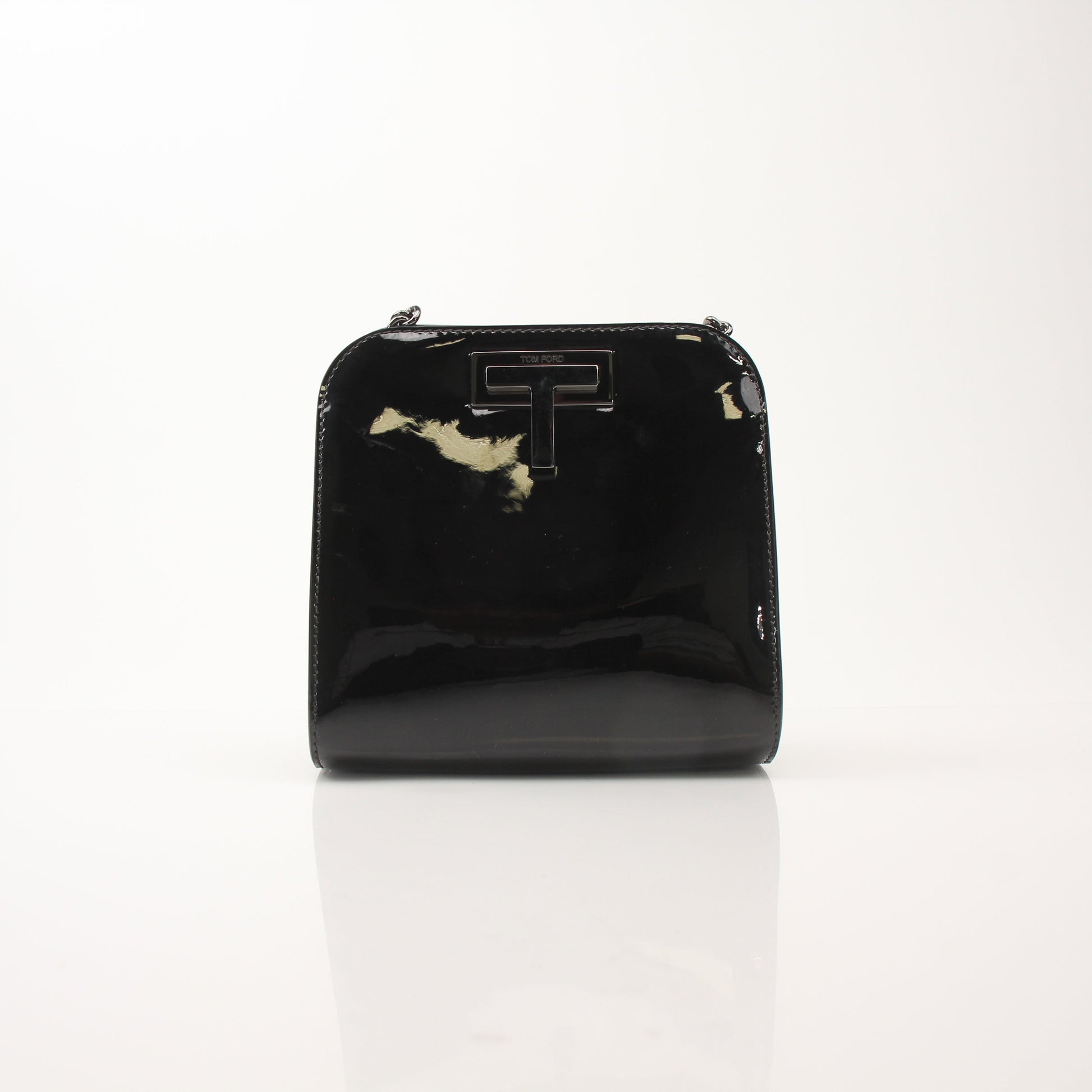 Black Tom Ford Black Cosmo handbag with gold accents, featuring sleek leather and structured design for elegant style.