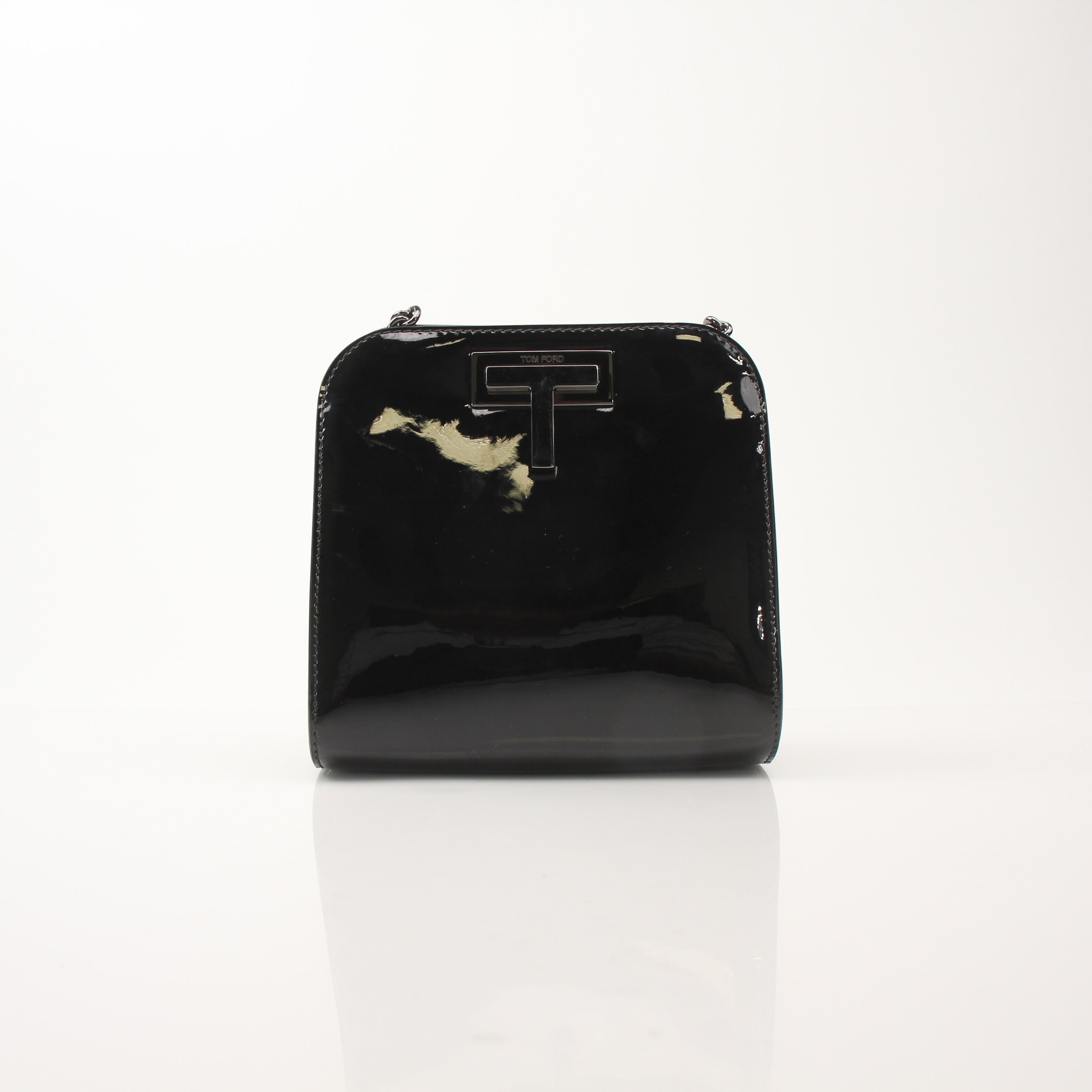 Black Tom Ford Black Cosmo handbag with gold accents, featuring sleek leather and structured design for elegant style.