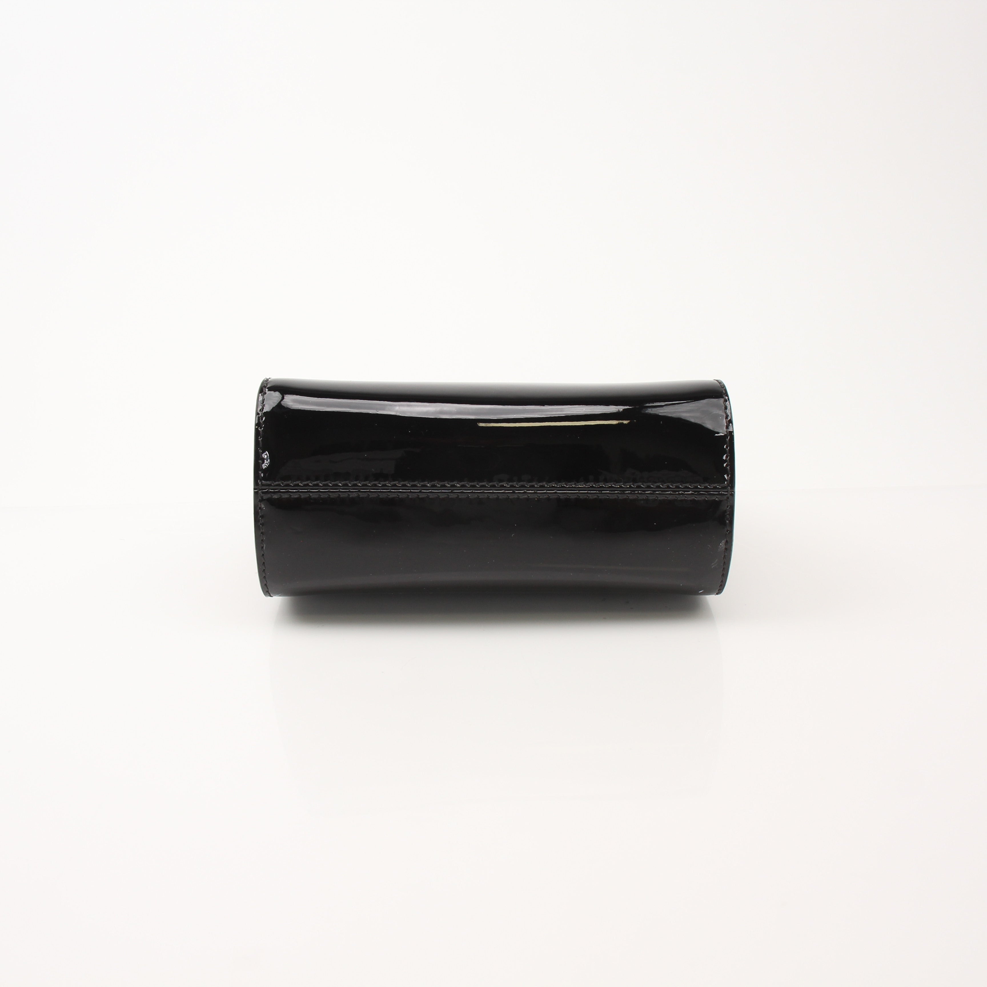 Black Tom Ford Cosmo handbag with gold accents, featuring sleek leather design and structured shape.