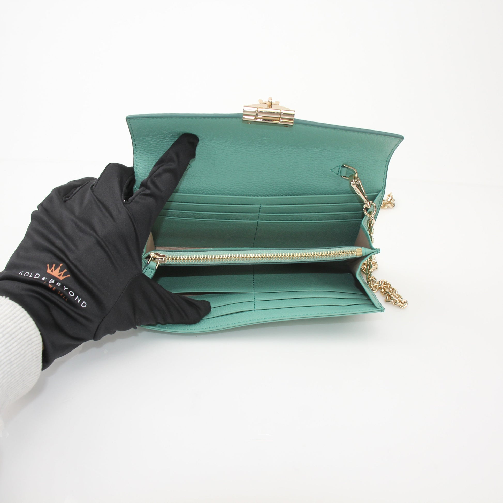 Gold & Beyond MCM Millie Mint wallet on chain, featuring a compact design with chain strap and signature logo details.
