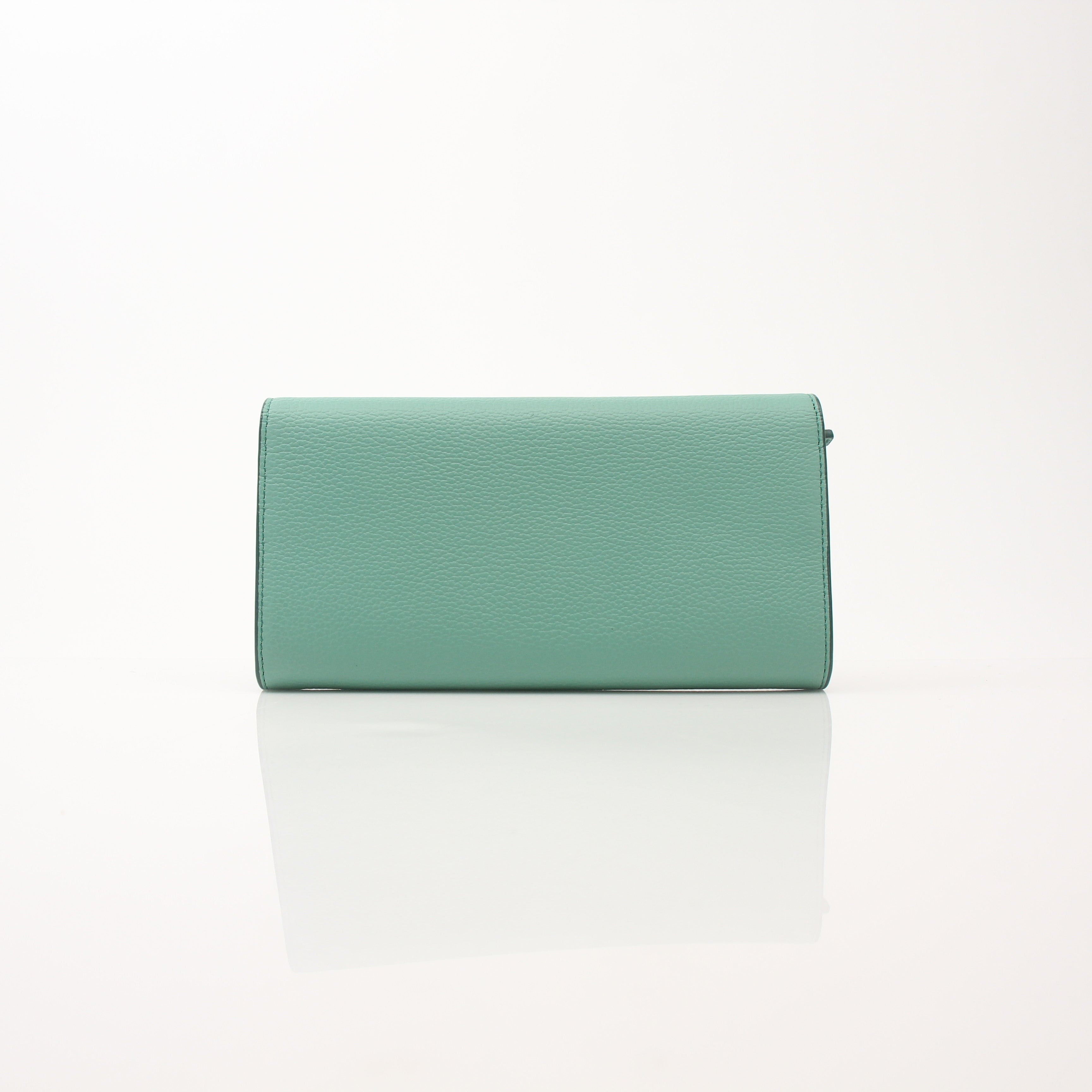 MCM Millie Mint Wallet on Chain by Gold & Beyond, featuring a sleek mint green leather wallet with chain strap and gold-tone accents.
