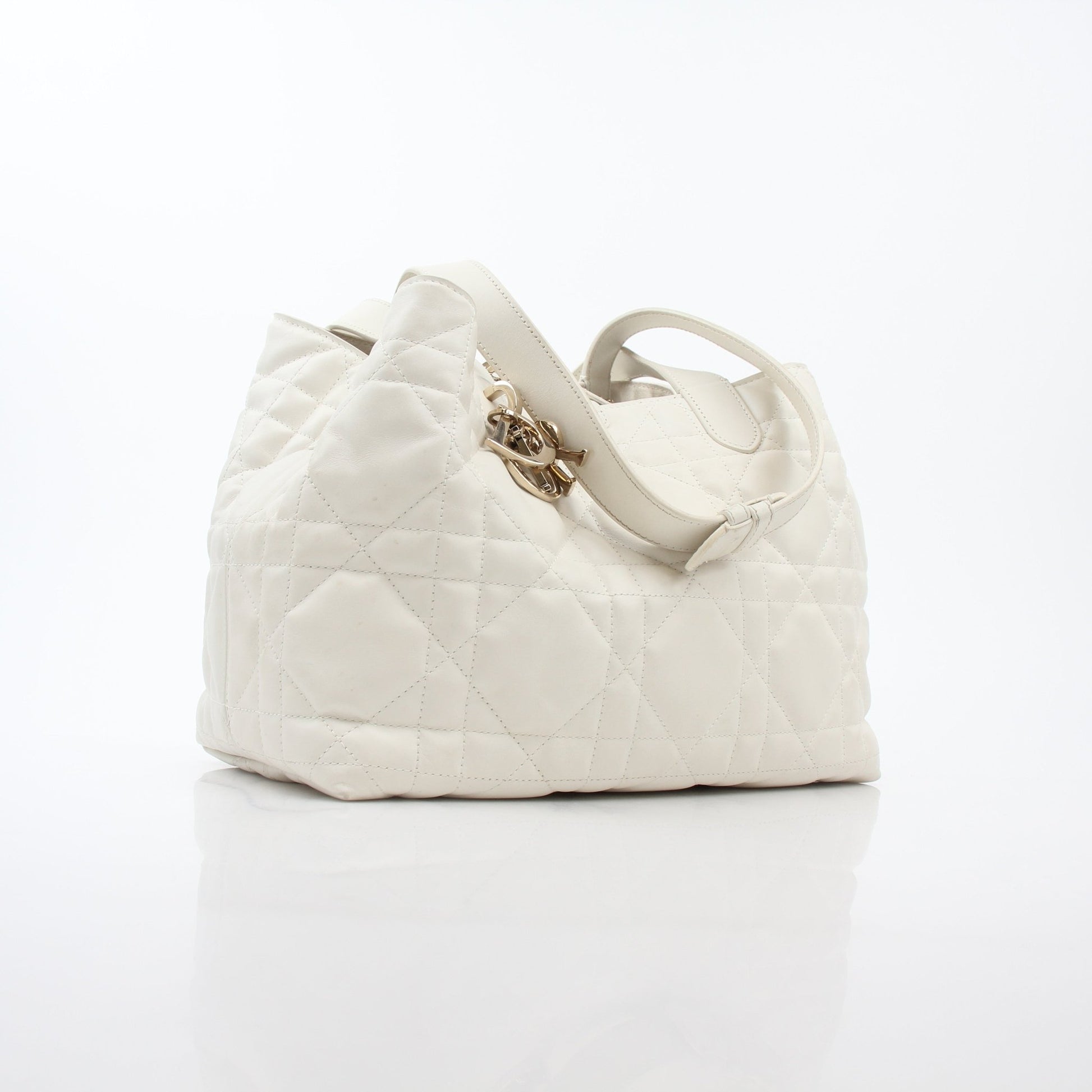 Christian Dior Latte Macrocannage Toujours tote handbag in beige with gold accents and structured design.