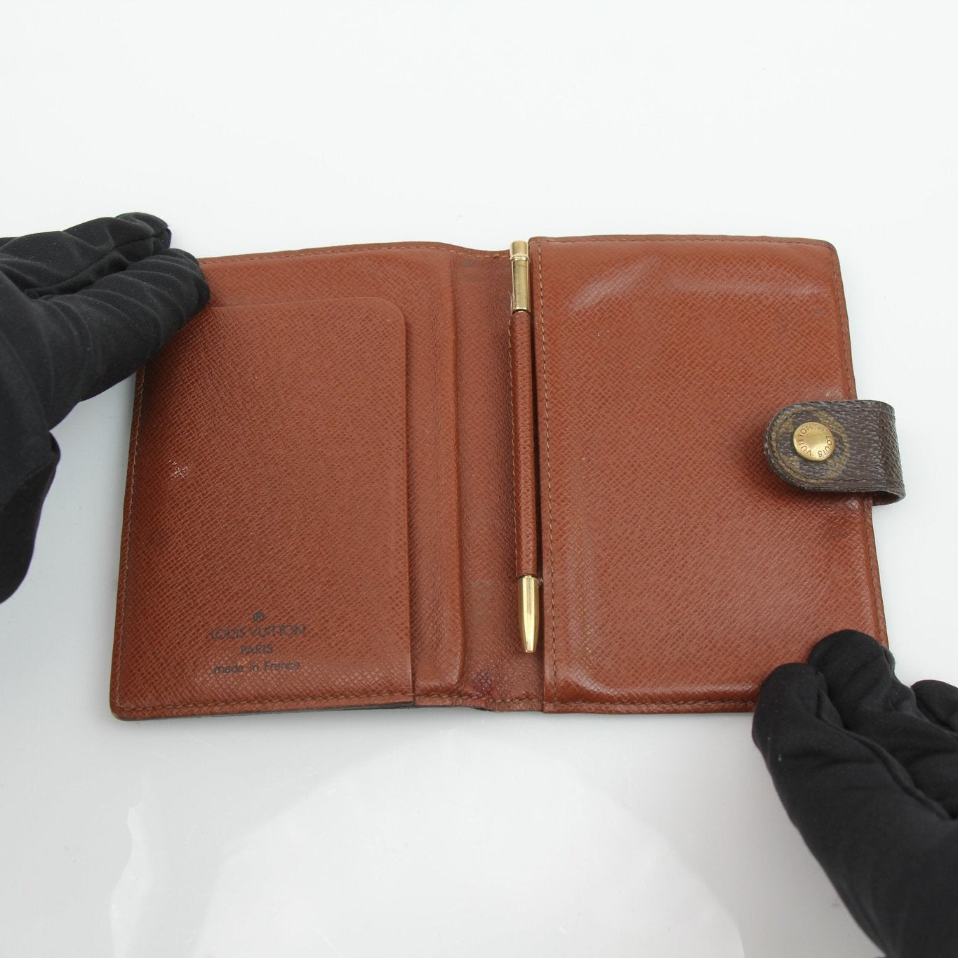 Louis Vuitton Monogram Agenda Cover wallet with gold accents, featuring signature monogram pattern and leather details.