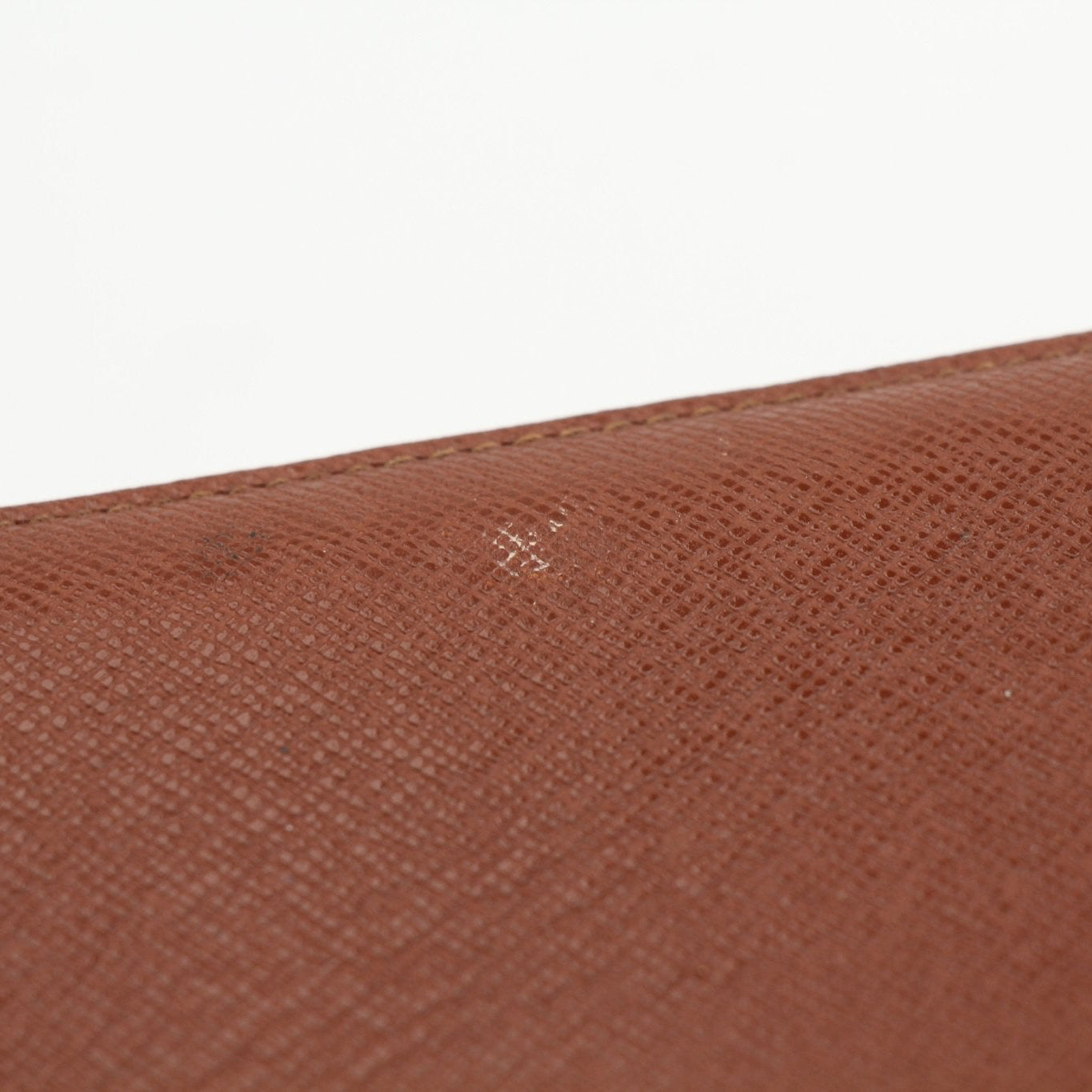 Louis Vuitton Monogram Agenda Cover wallet with gold accents and monogram pattern, featuring multiple card slots and a sleek design.