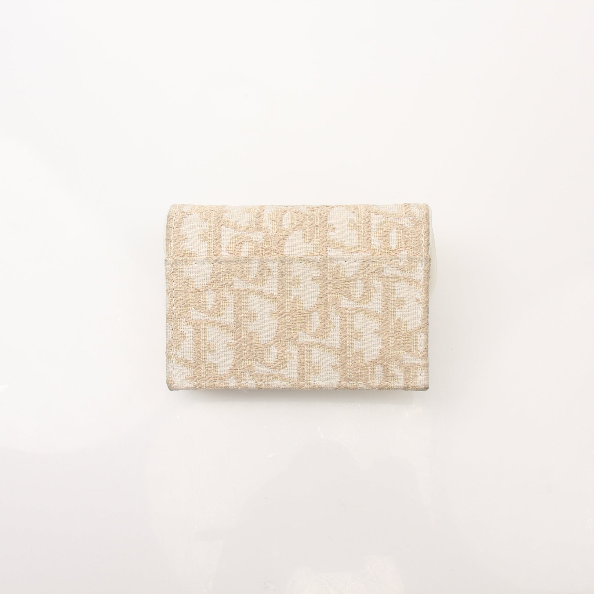 Christian Dior Compact Saddle Wallet by Gold & Beyond, showcasing a stylish leather wallet with saddle design and gold-tone accents.