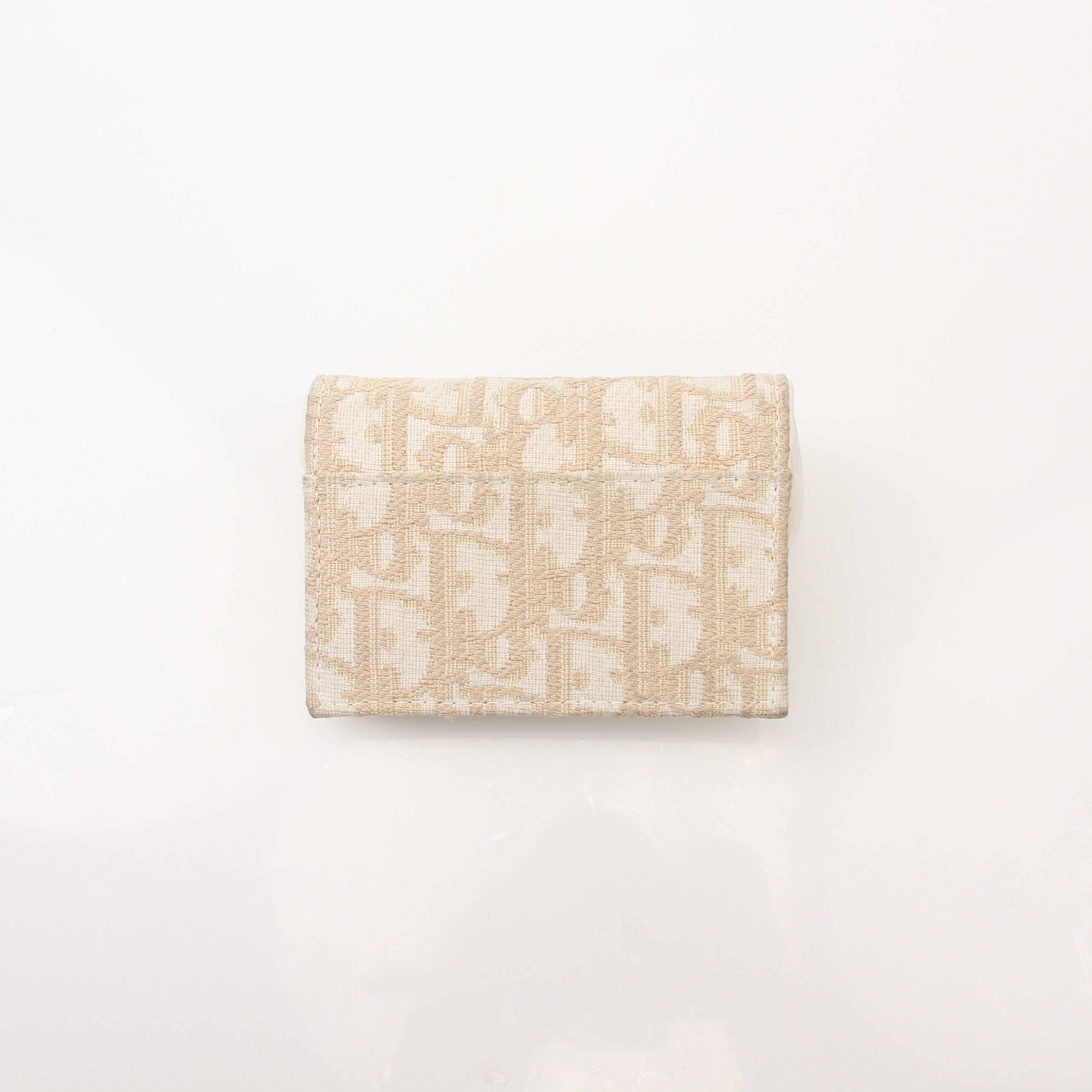 Christian Dior Compact Saddle Wallet by Gold & Beyond, showcasing a stylish leather wallet with saddle design and gold-tone accents.