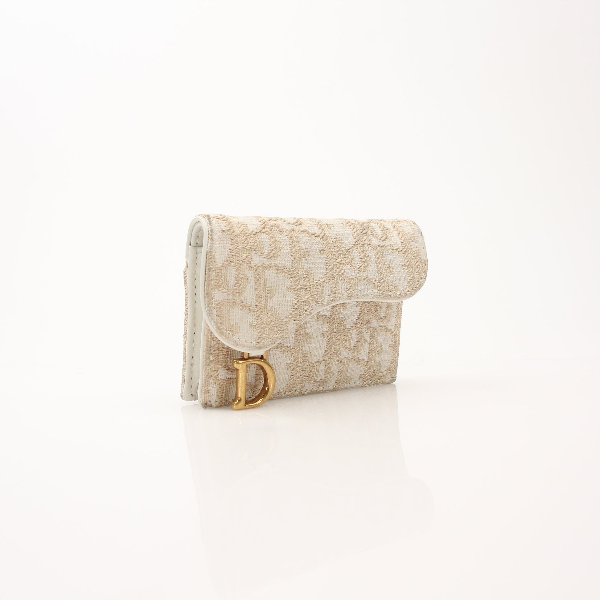 Christian Dior compact saddle wallet from Gold & Beyond, showing detailed leather design and compact wallet features.