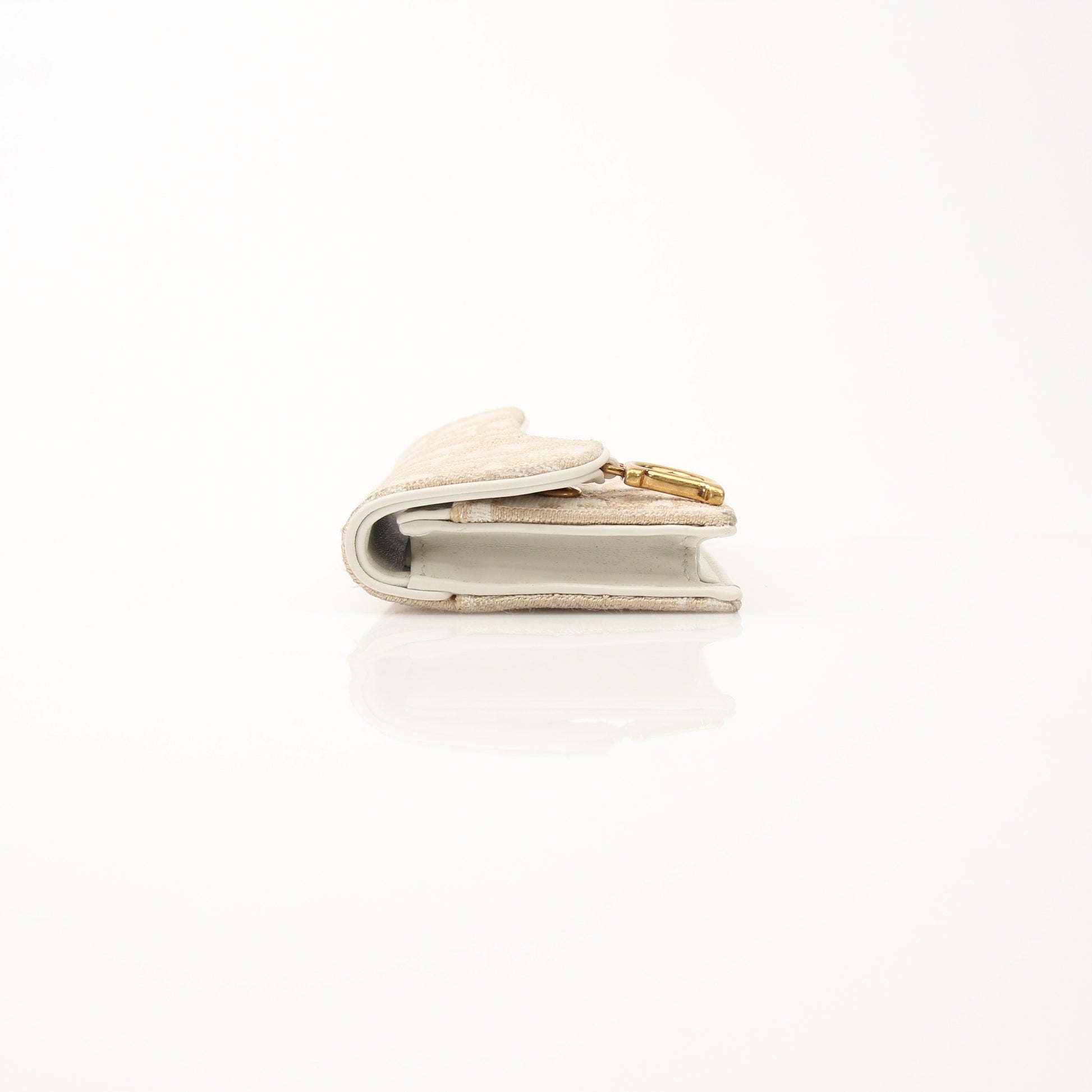 Christian Dior Compact Saddle Wallet by Gold & Beyond, showing the leather exterior with saddle design and compact size.