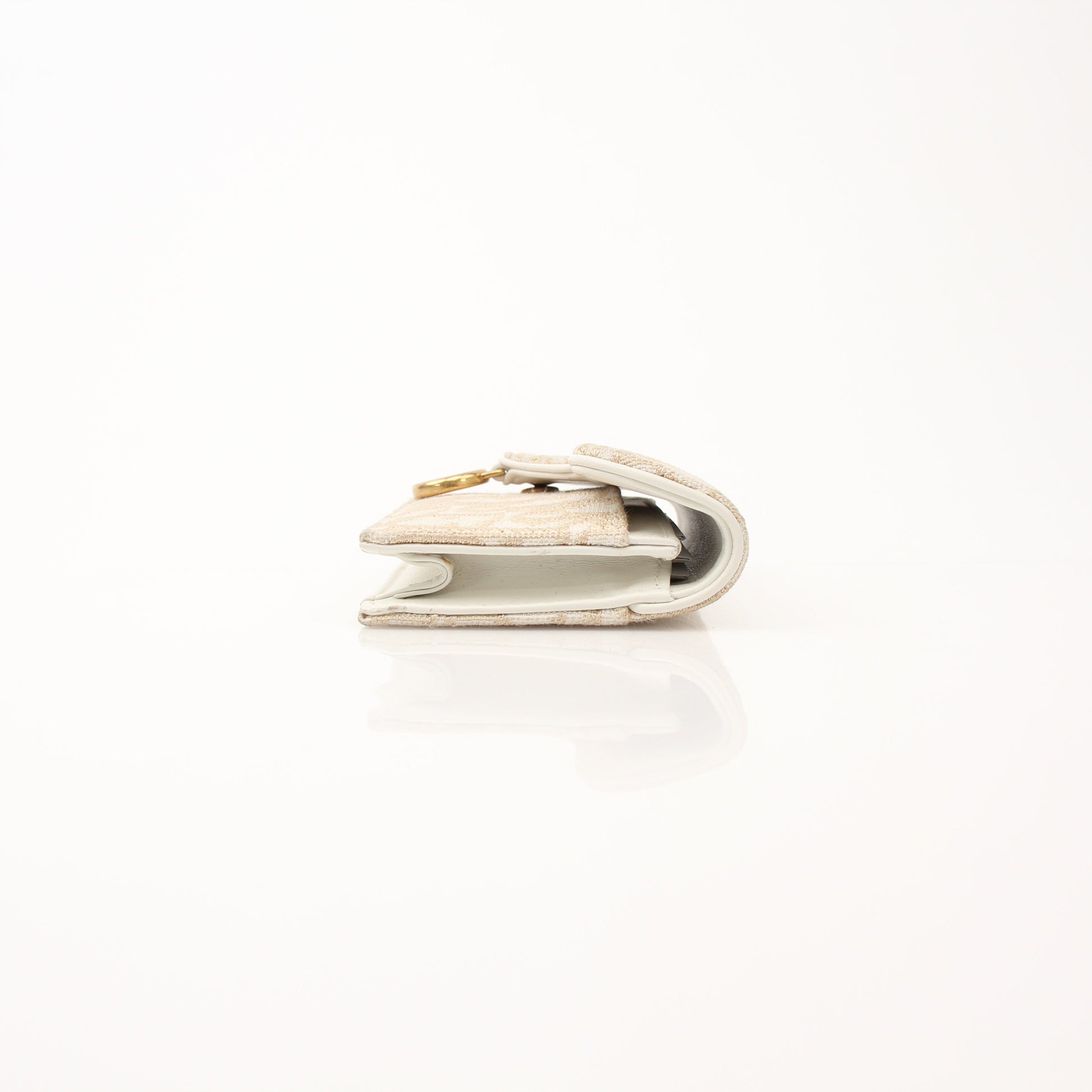 Christian Dior Compact Saddle Wallet by Gold & Beyond, featuring a sleek leather design with saddle-stitch details.