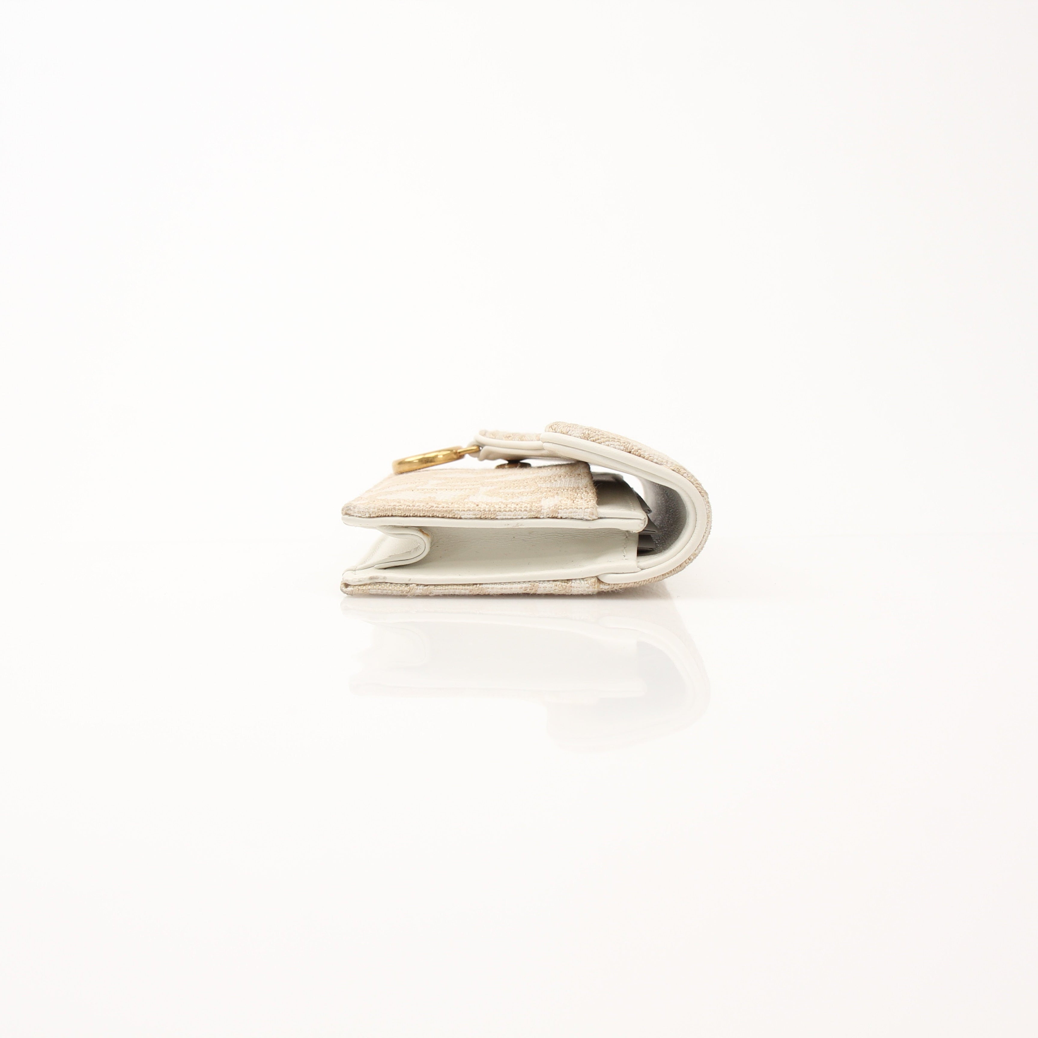 Christian Dior Compact Saddle Wallet by Gold & Beyond, featuring a sleek leather design with saddle-stitch details.