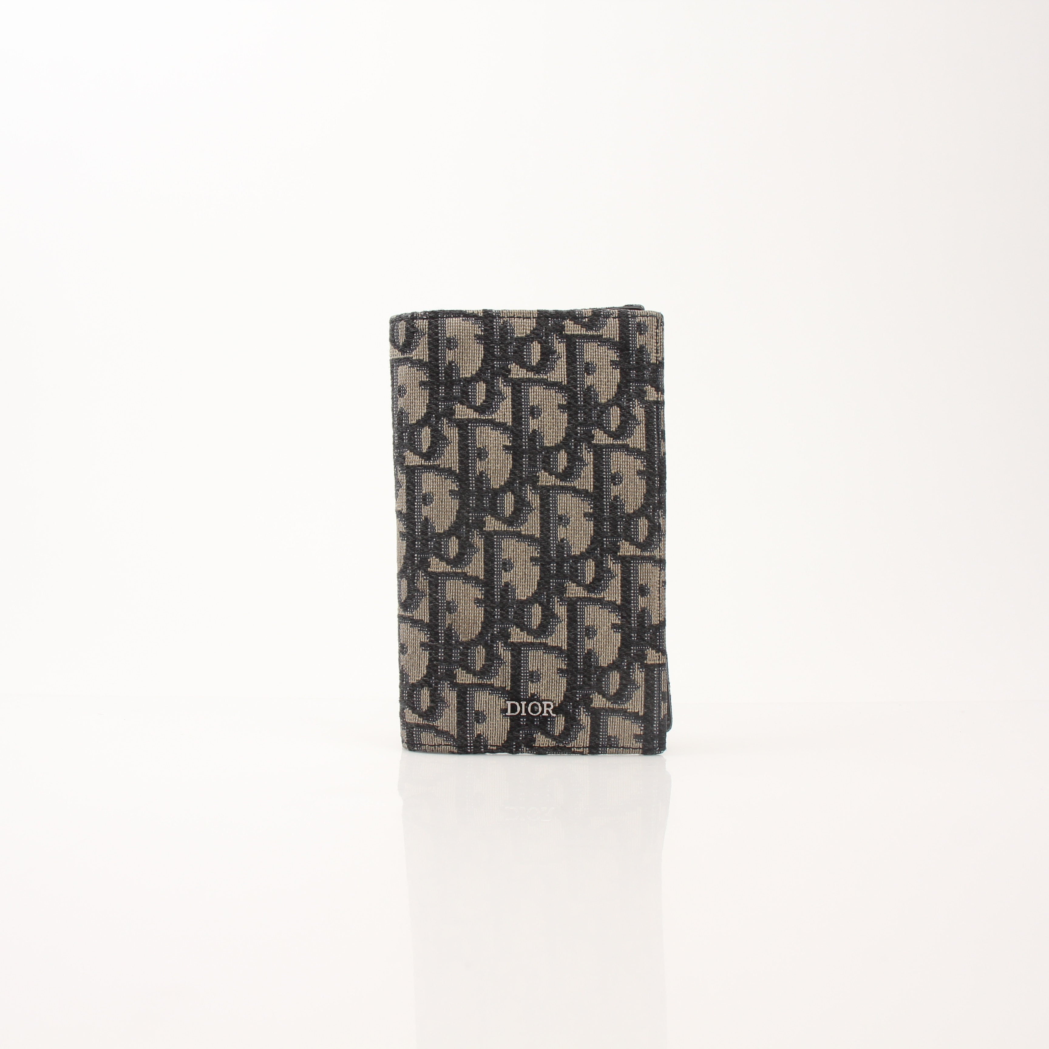 Christian Dior Oblique Blue Bifold Wallet with gold accents, featuring the signature Dior pattern and multiple card slots.