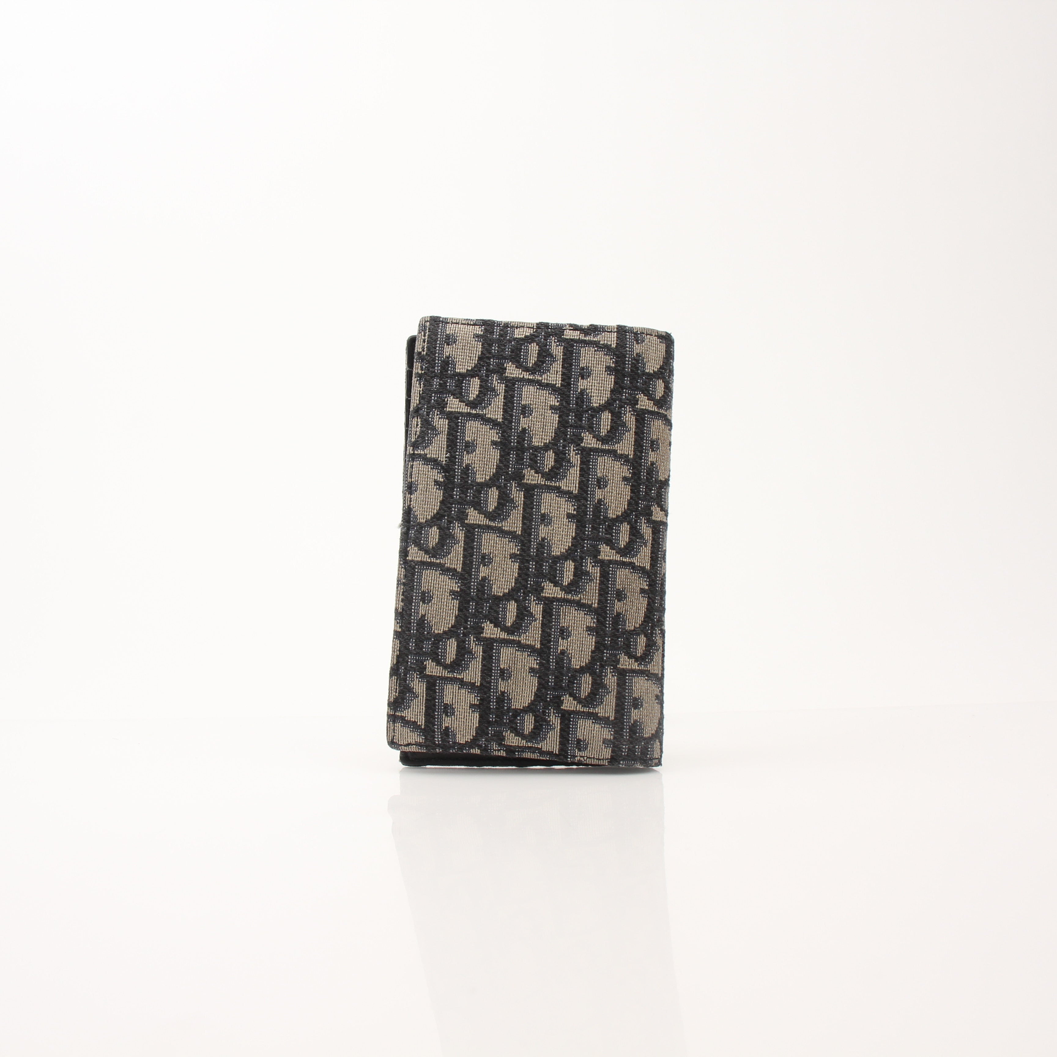 Christian Dior Oblique blue bifold wallet with gold accents, featuring multiple card slots and a sleek, compact design.