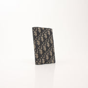 Christian Dior Oblique blue bifold wallet with gold accents, showcasing the iconic pattern and leather interior.