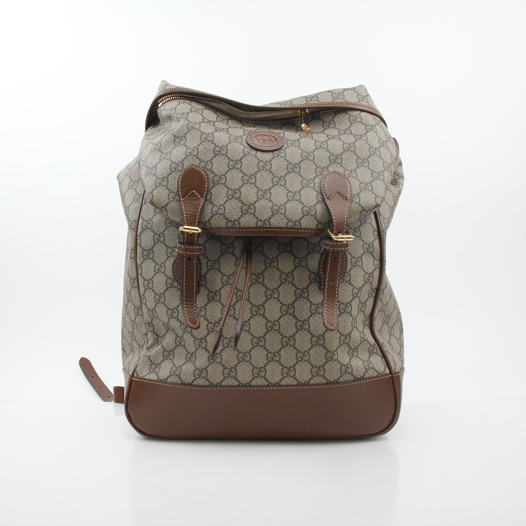 Gucci GG Supreme Interlocking G double buckle travel backpack with adjustable straps and spacious main compartment.
