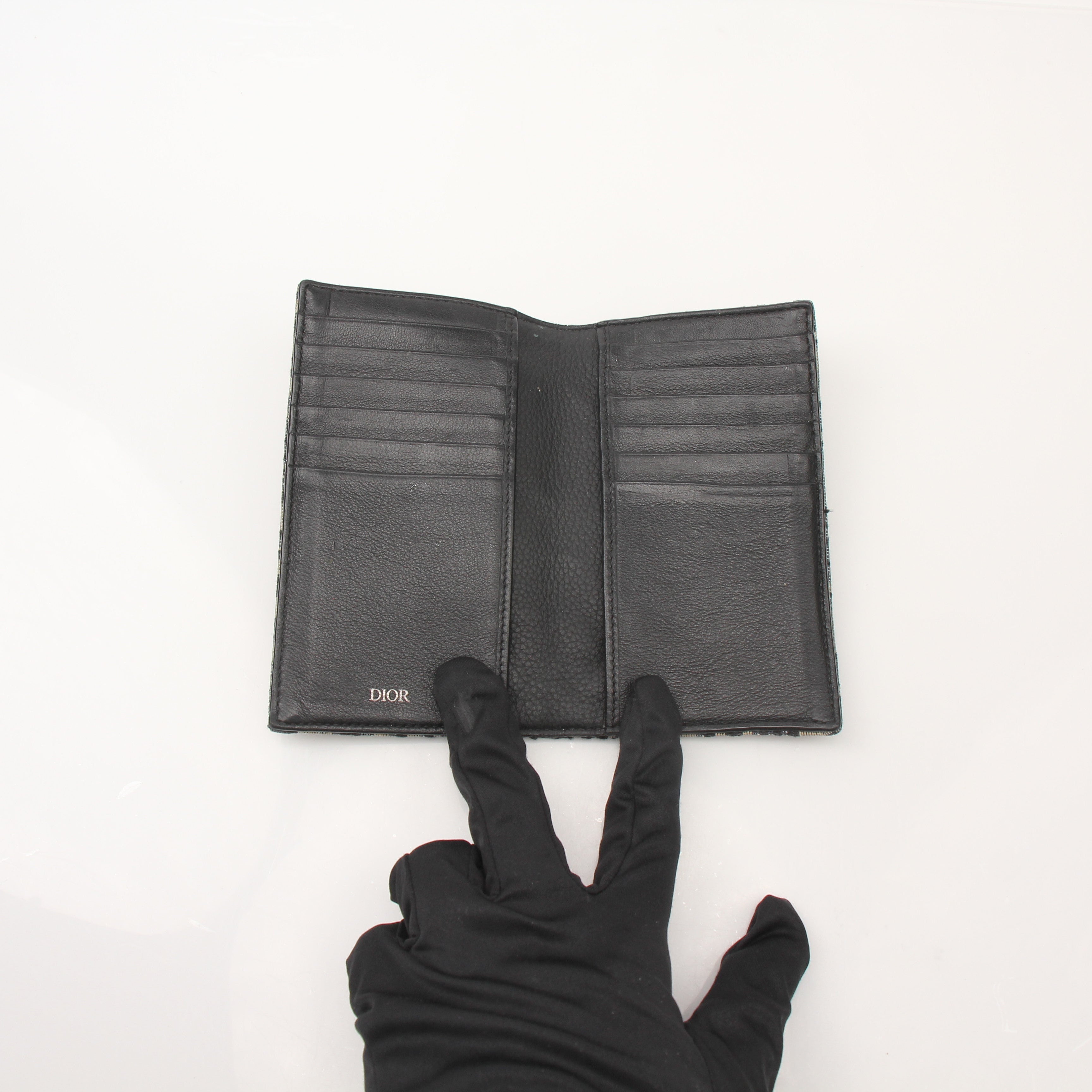 Christian Dior Oblique blue bifold wallet with gold accents and multiple card slots, made by Gold & Beyond.