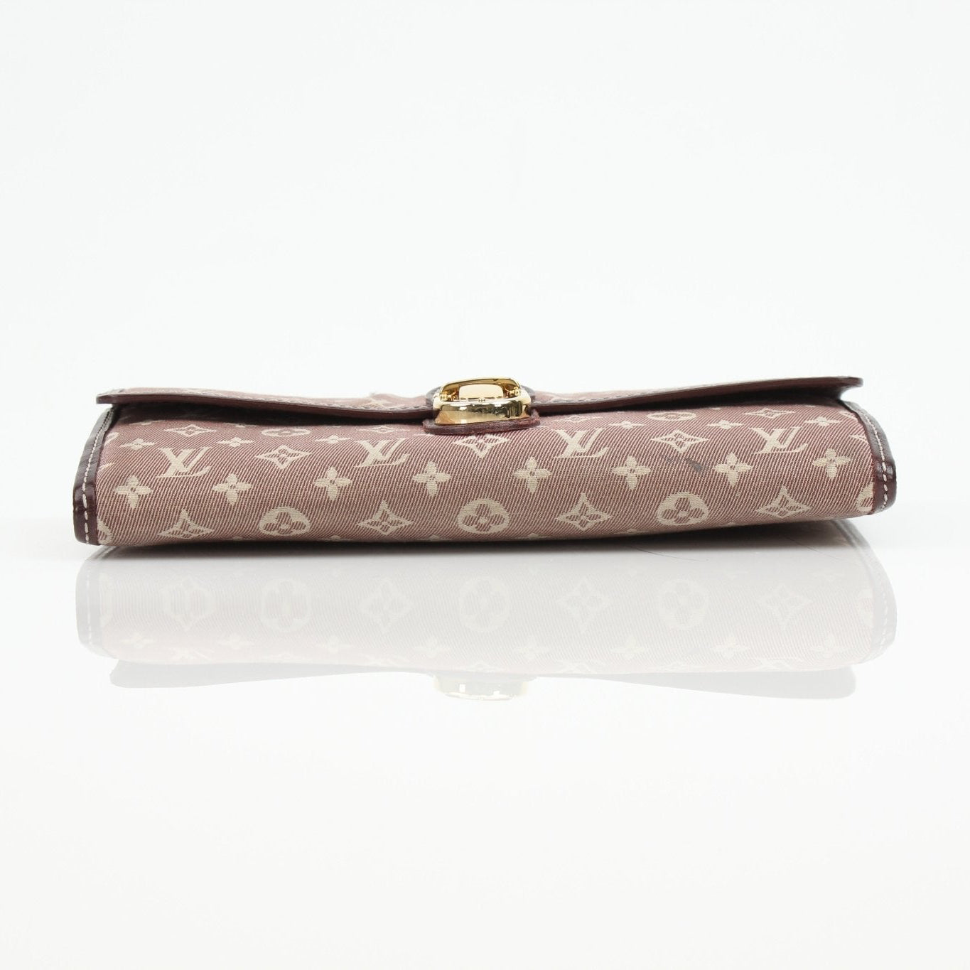 Louis Vuitton Sarah Monogram Wallet showing its classic monogram canvas and gold-tone hardware on a flat surface.