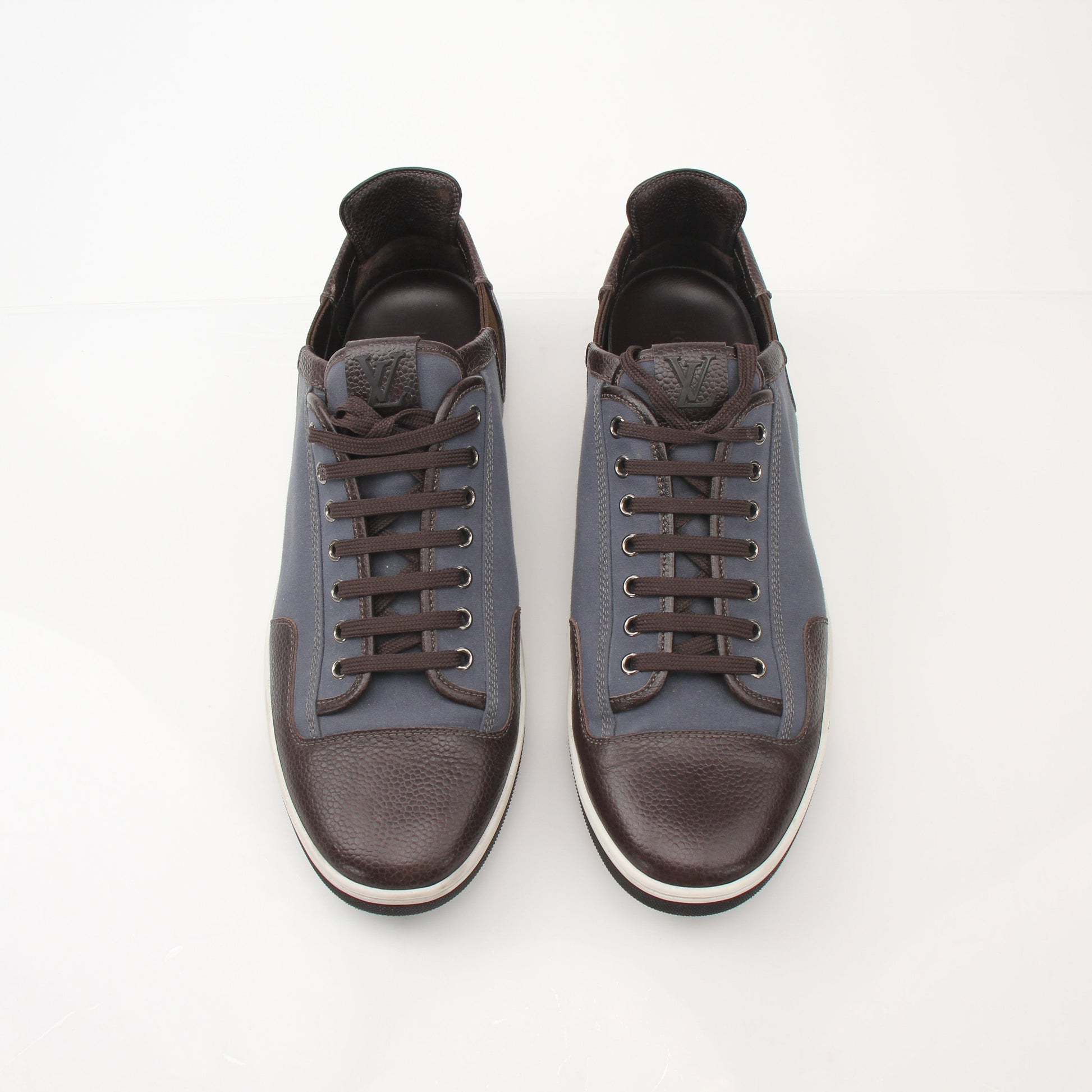Louis Vuitton Men’s Shalom leather sneakers in black with white soles, featuring sleek design and Louis Vuitton branding.