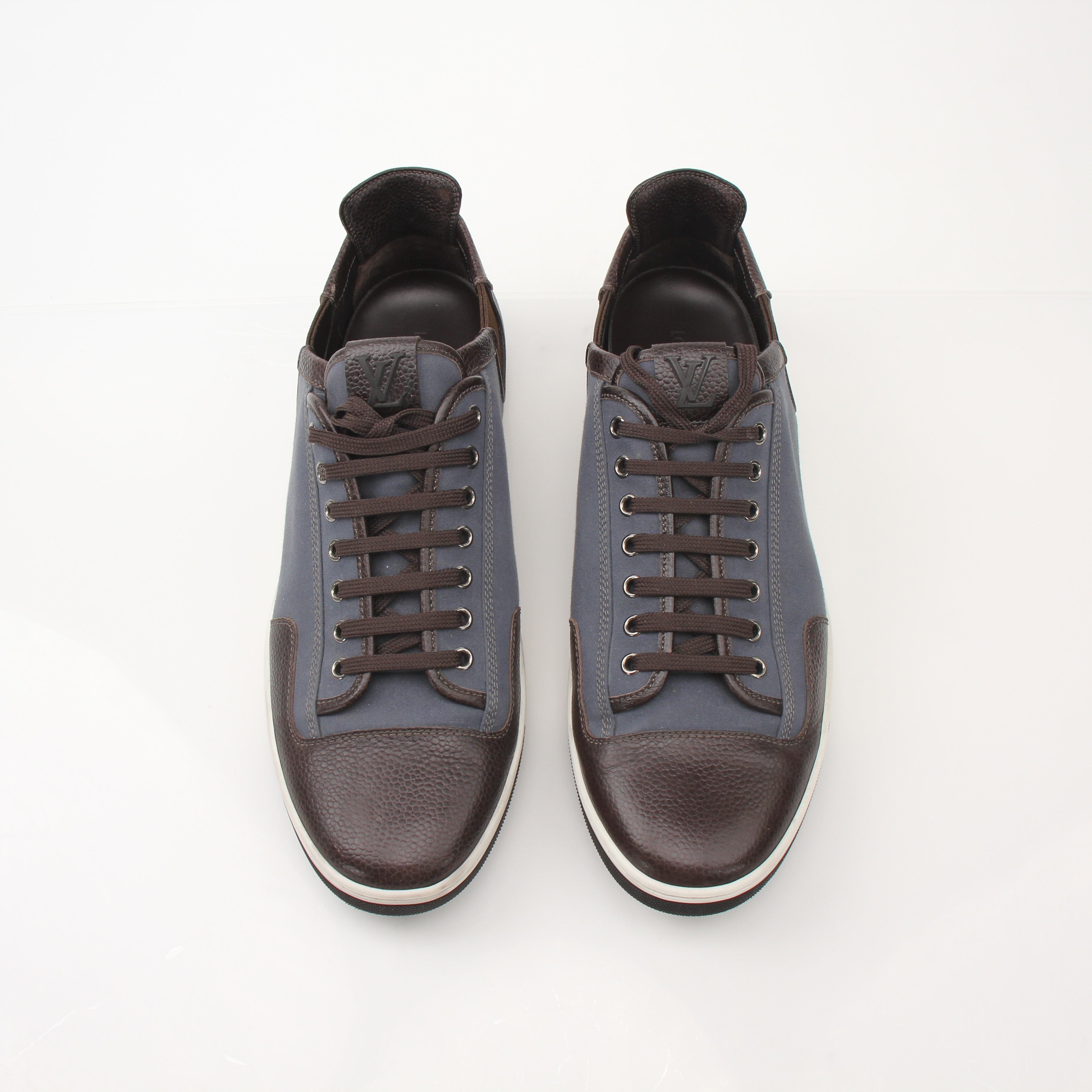 Louis Vuitton Men’s Shalom leather sneakers in black with white soles, featuring sleek design and Louis Vuitton branding.