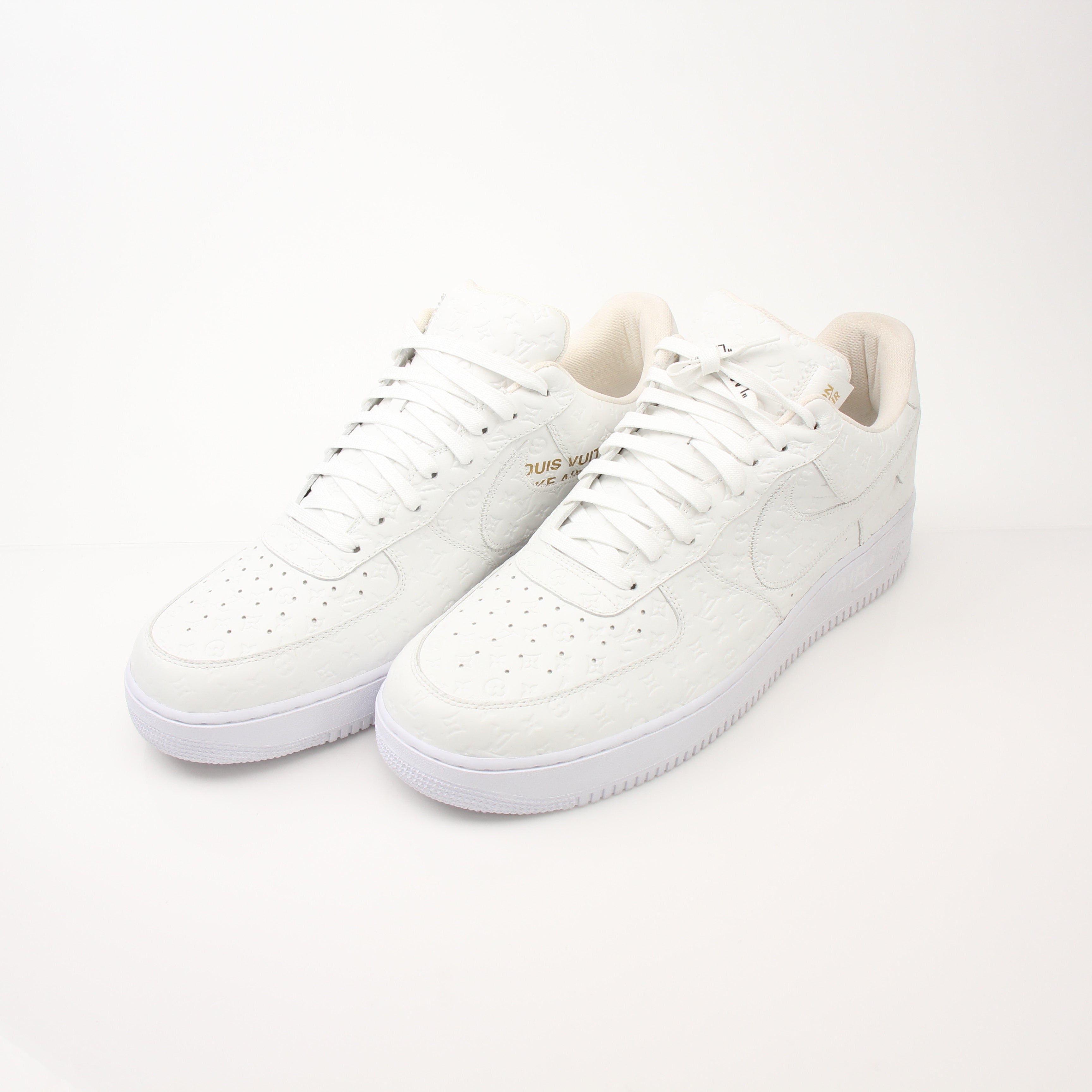 Louis Vuitton x Nike Air Force 1 Low sneakers in black and white with gold accents, featuring classic Nike branding and premium design.
