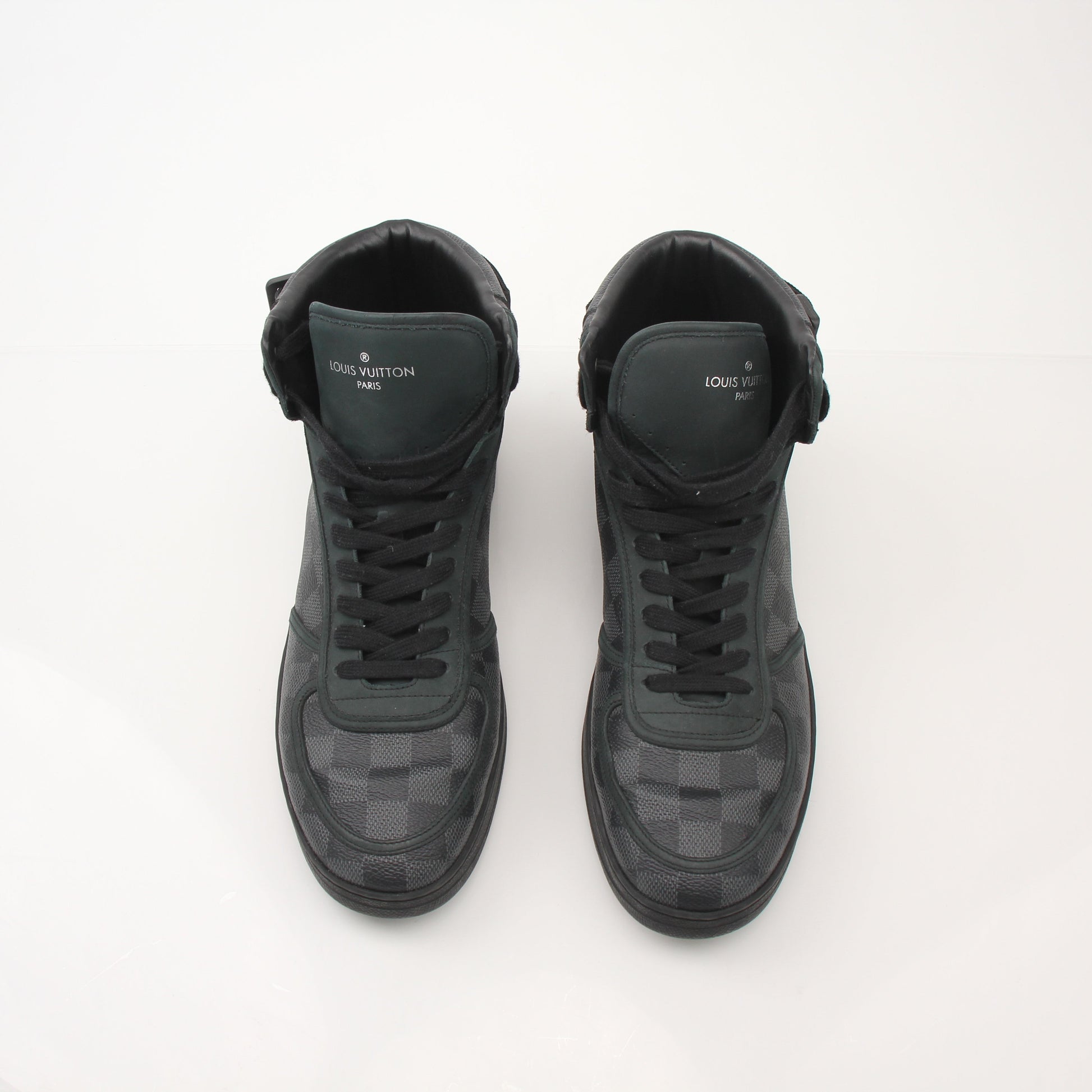 Louis Vuitton men's Rivoli high top sneakers in black leather with gold accents, showing stylish shoe design and laces.