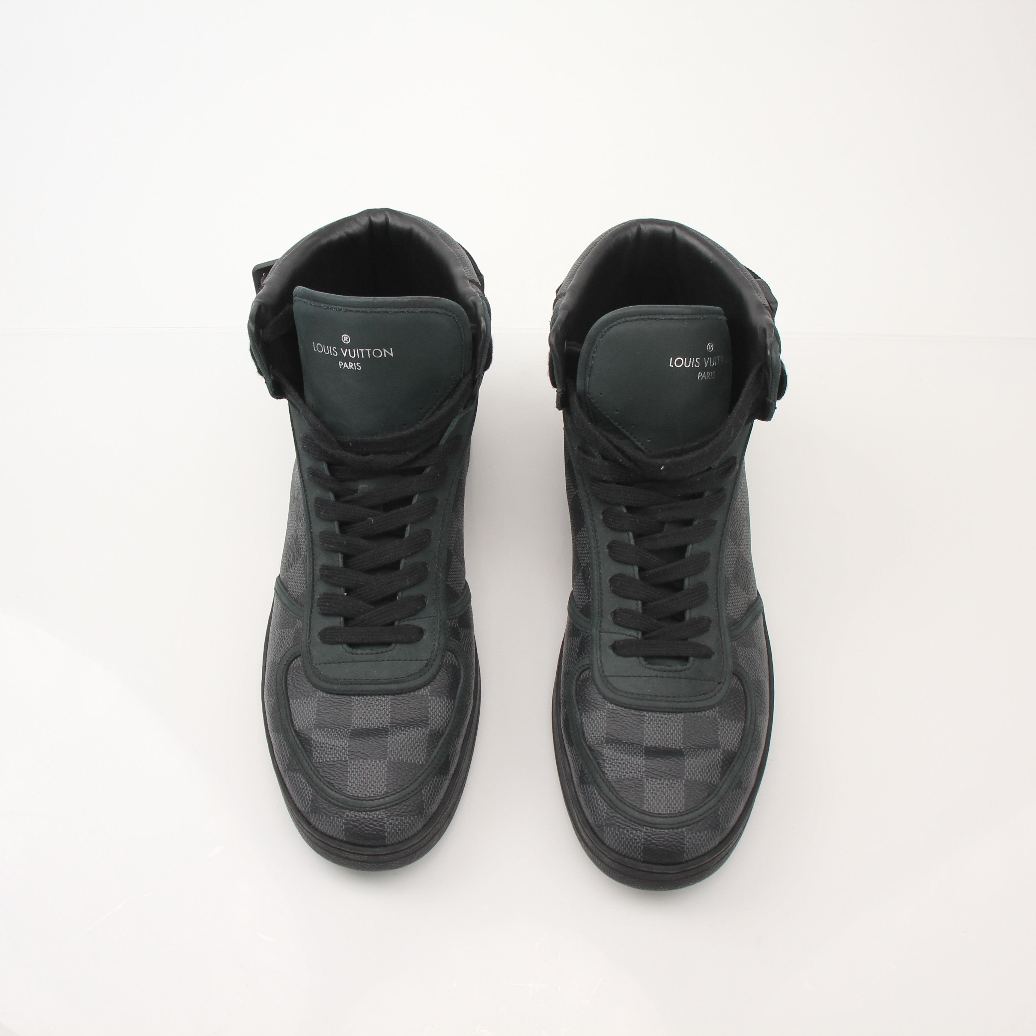 Louis Vuitton men's Rivoli high top sneakers in black leather with gold accents, showing stylish shoe design and laces.