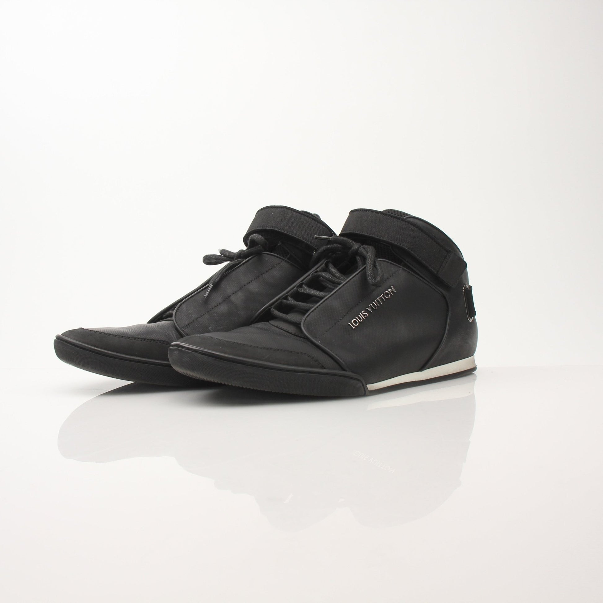 Louis Vuitton men's black mid-top sneakers featuring sleek design, leather accents, and stylish laces from Gold & Beyond.
