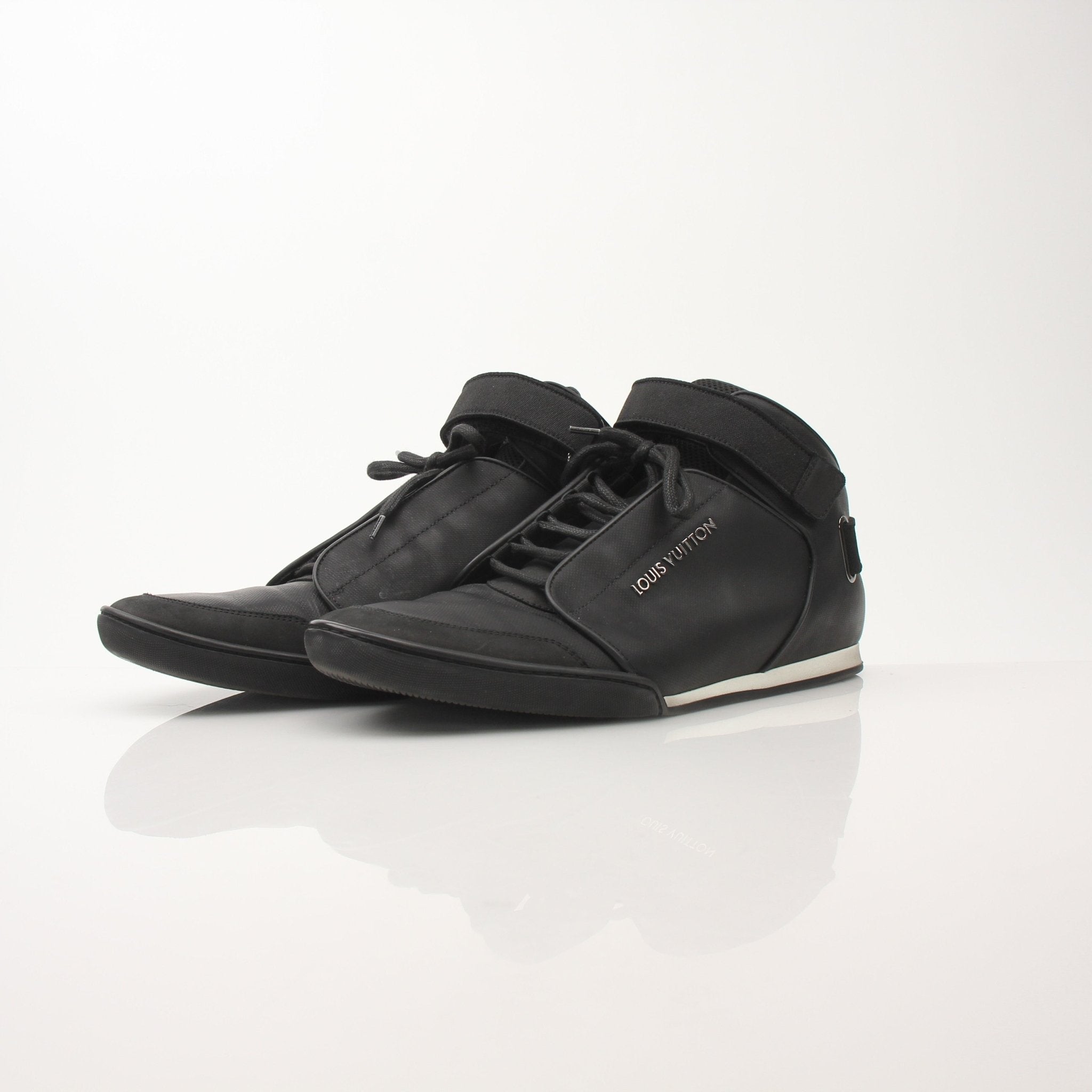 Louis Vuitton men's black mid-top sneakers featuring sleek design, leather accents, and stylish laces from Gold & Beyond.
