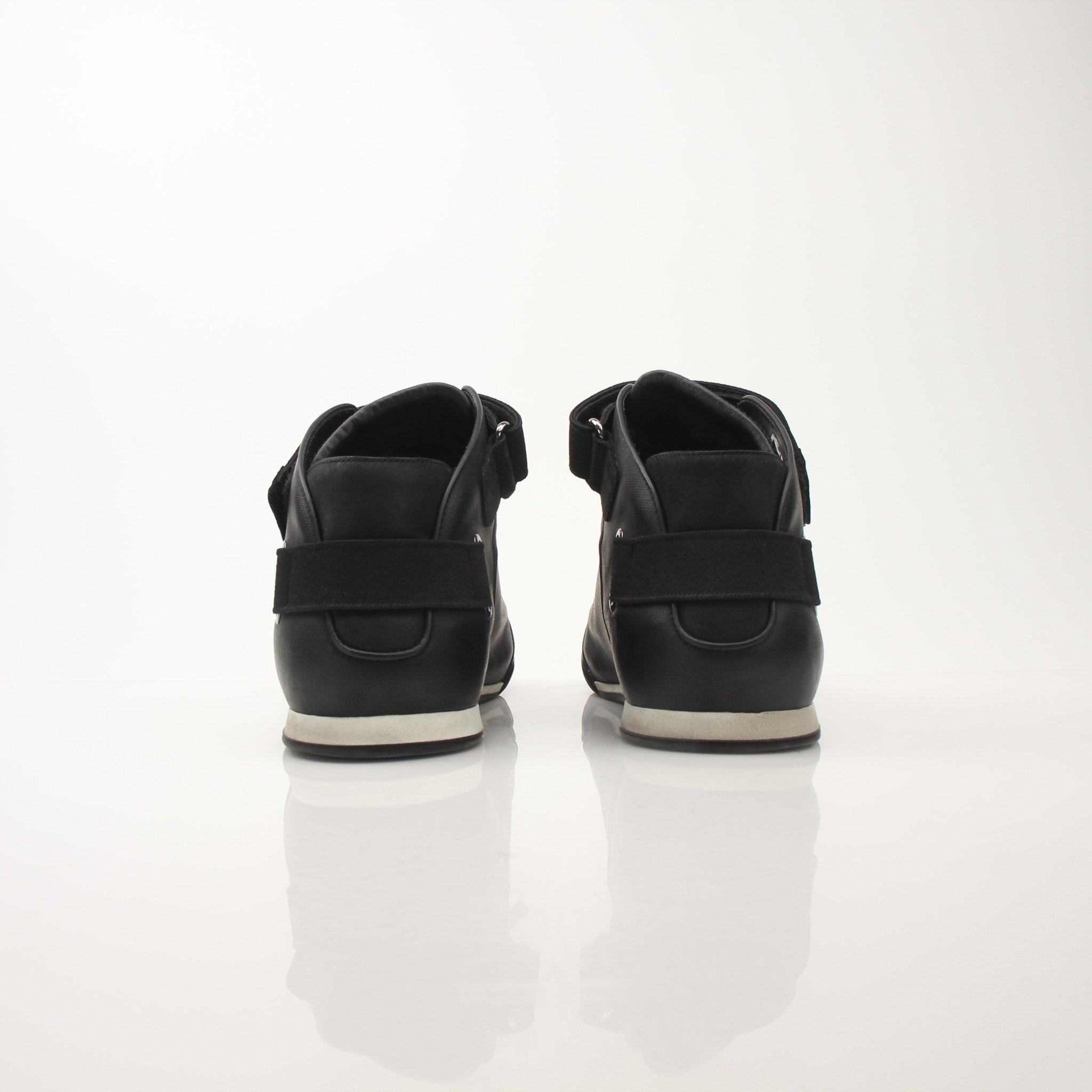 Louis Vuitton men's black mid-top sneakers with gold accents, stylish shoes with laces and a sleek design.