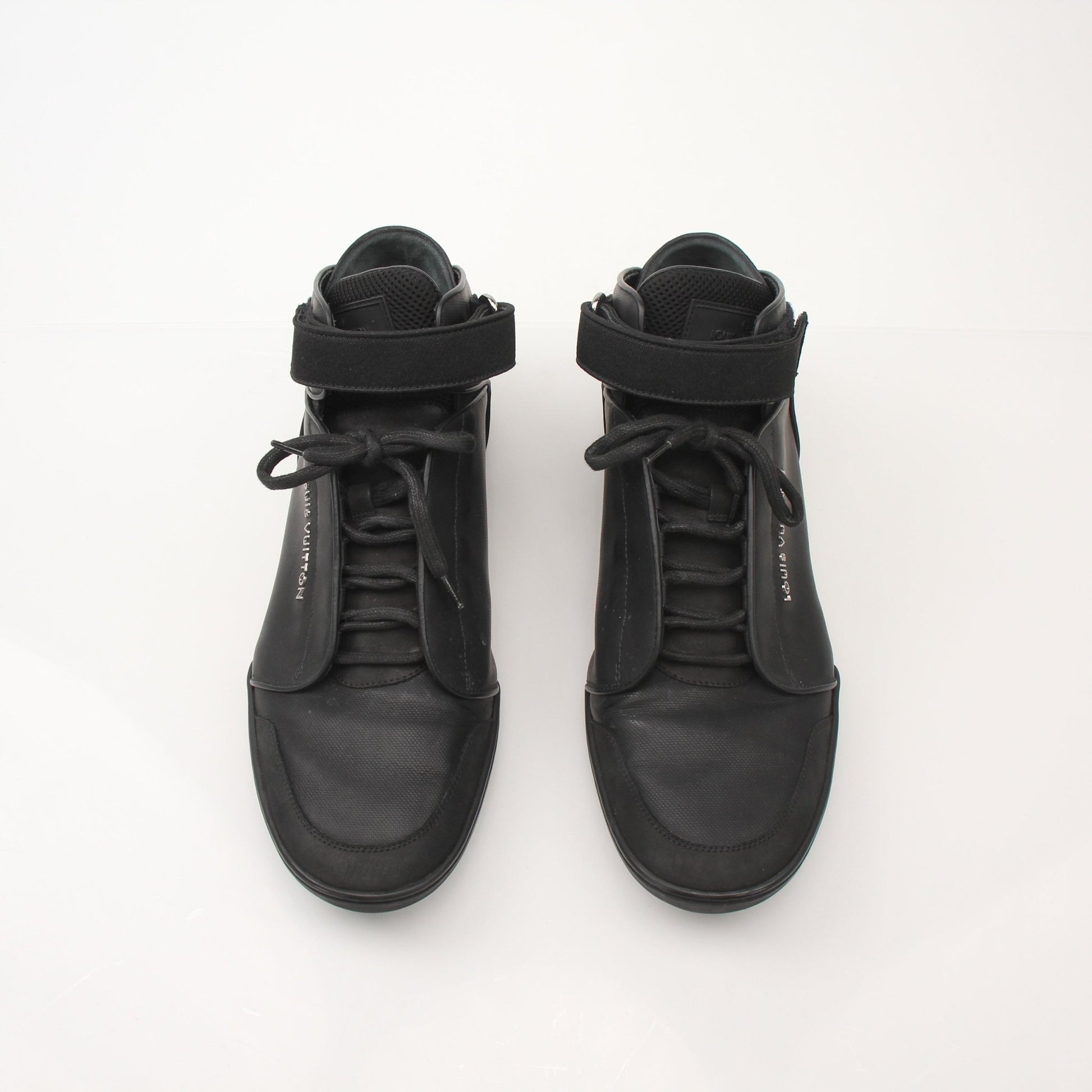 Louis Vuitton men's black mid-top sneakers with gold accents and stylish design, displayed on a plain background.