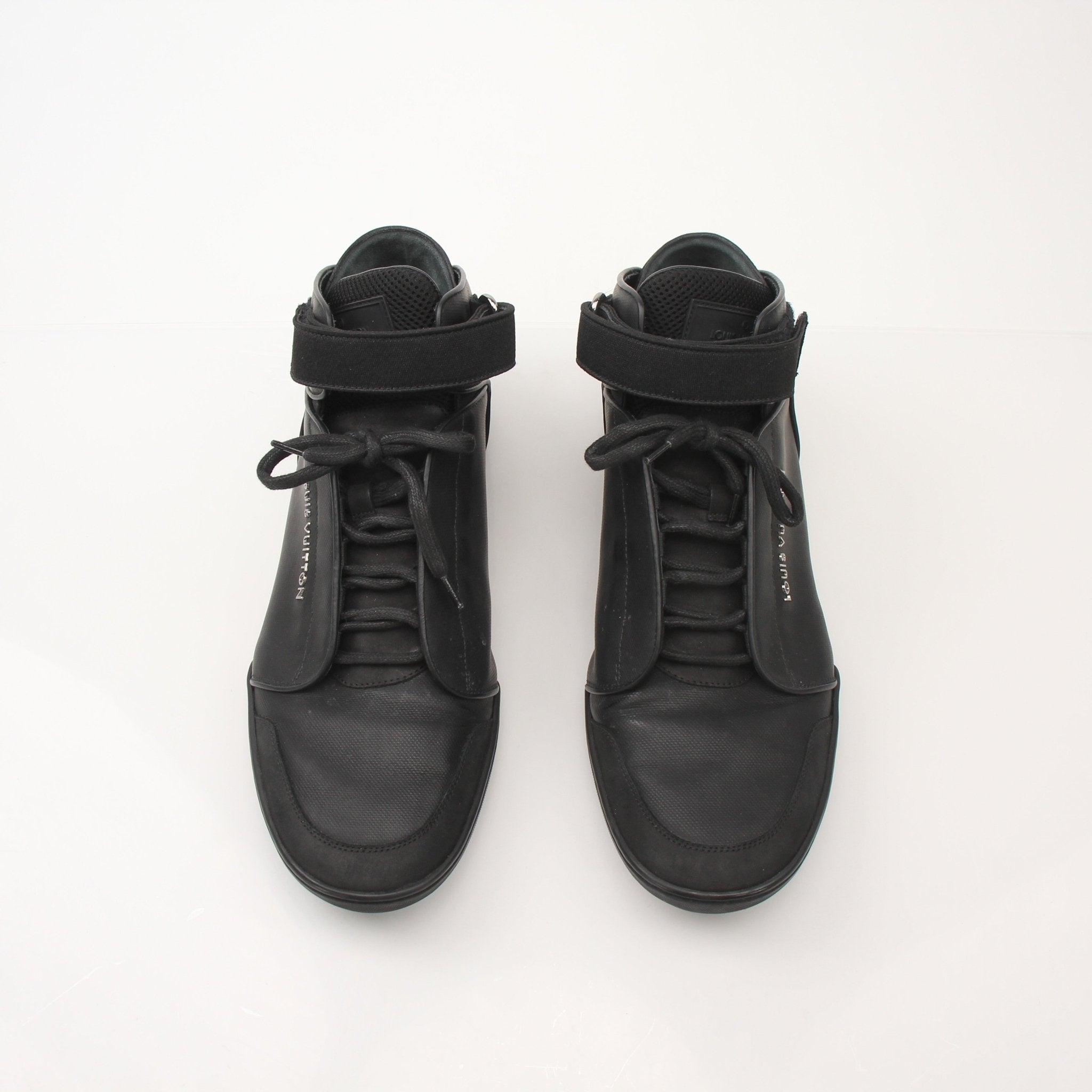 Louis Vuitton men's black mid-top sneakers with gold accents and stylish design, displayed on a plain background.
