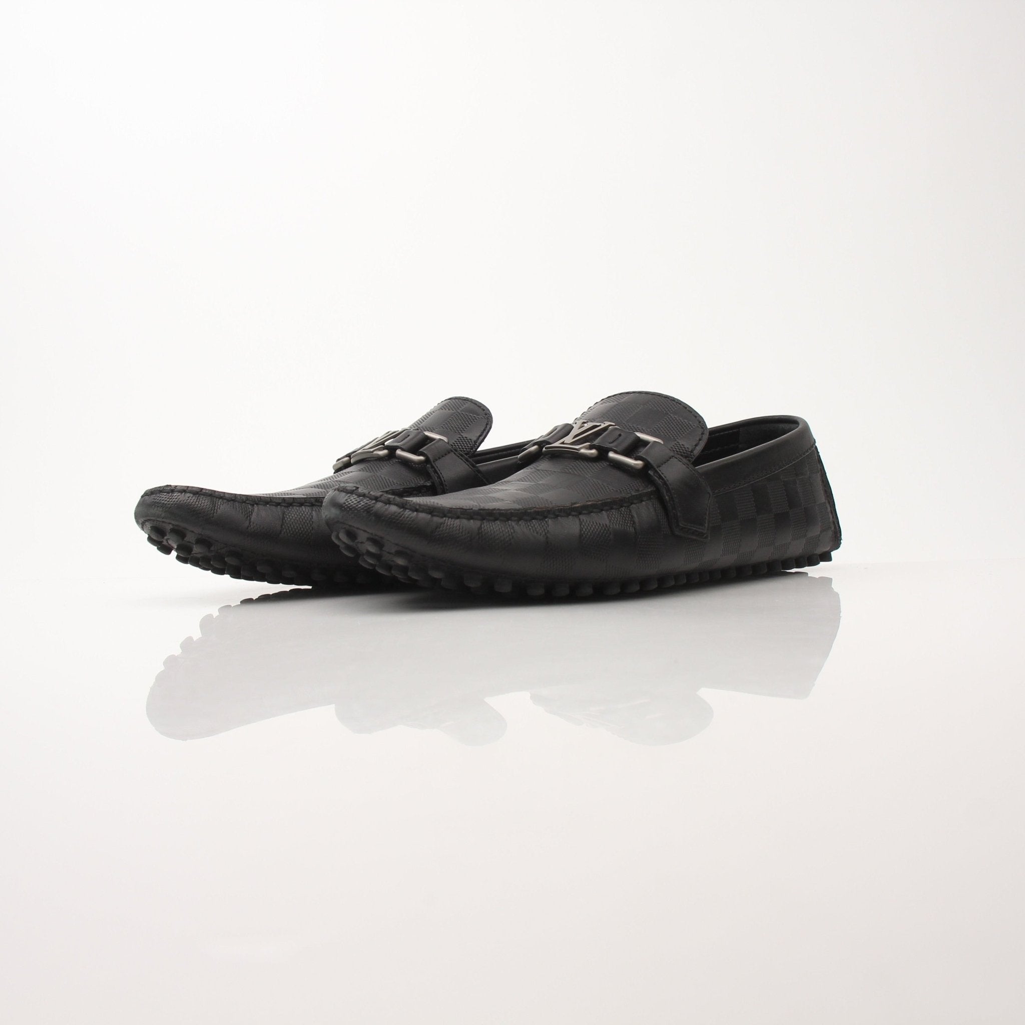 Gold & Beyond Louis Vuitton Hockenheim Moccasin shoes, stylish leather footwear with detailed stitching and classic design.