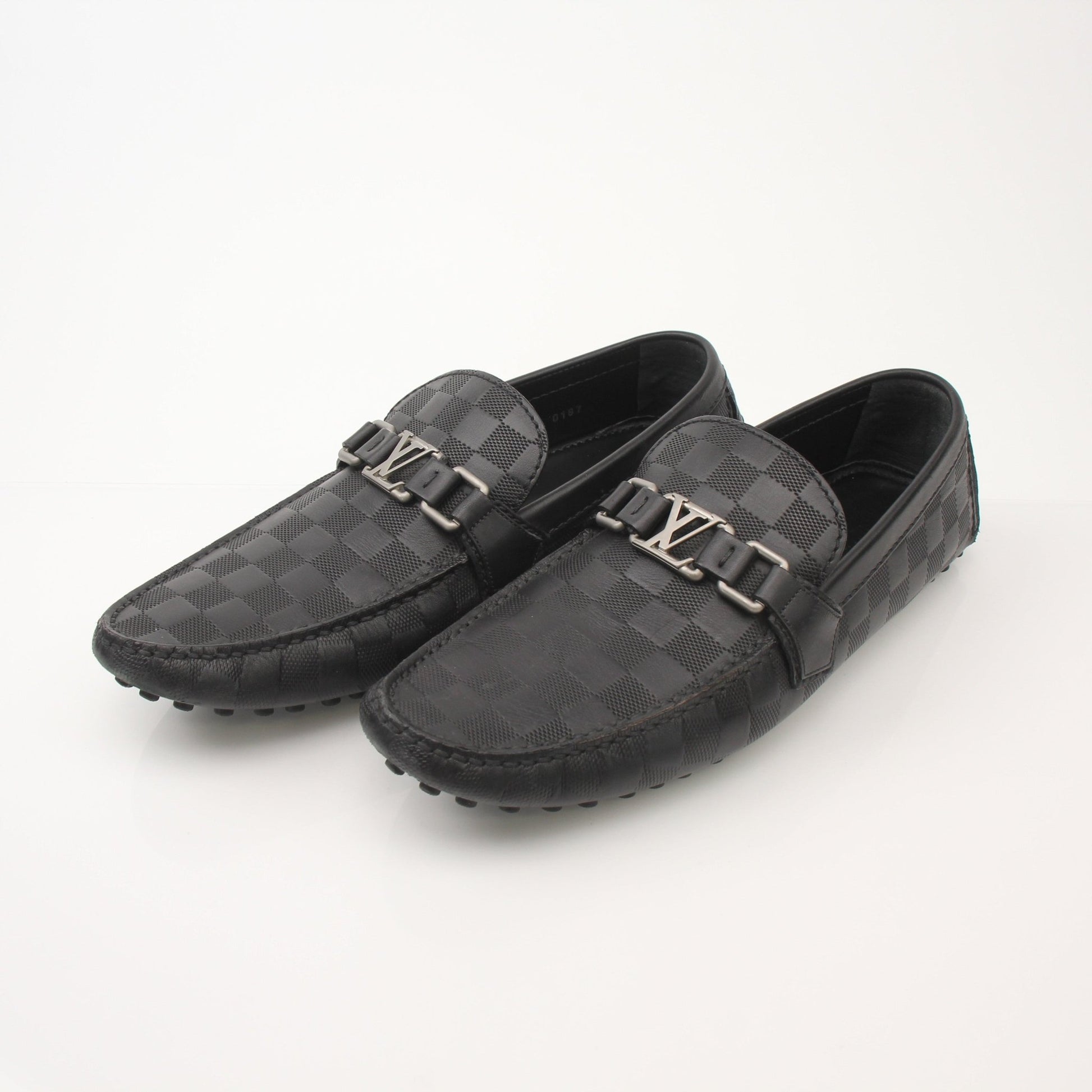 Louis Vuitton Hockenheim Moccasins shoes in tan leather with gold accents, featuring classic slip-on design and detailed stitching.