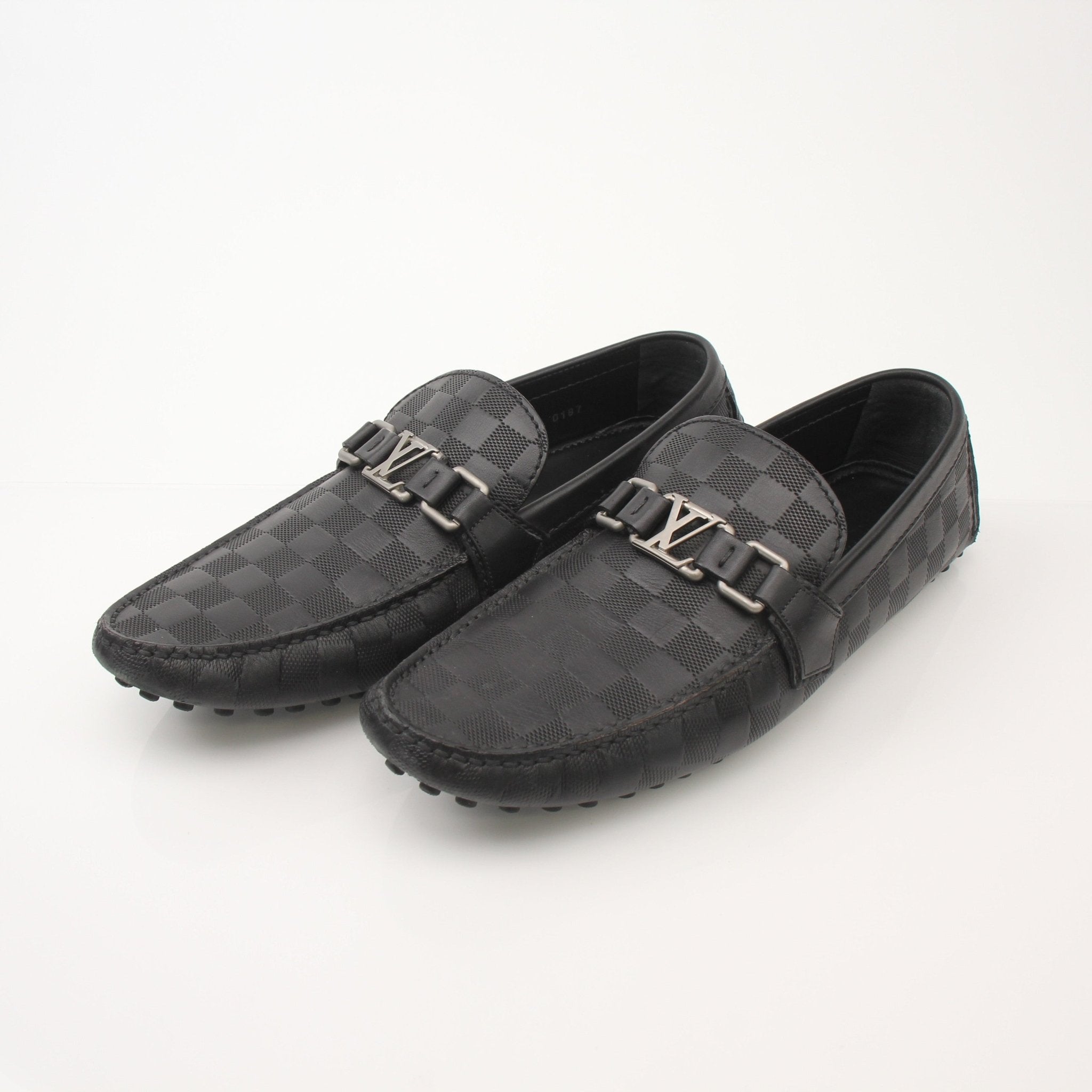 Louis Vuitton Hockenheim Moccasins shoes in tan leather with gold accents, featuring classic slip-on design and detailed stitching.